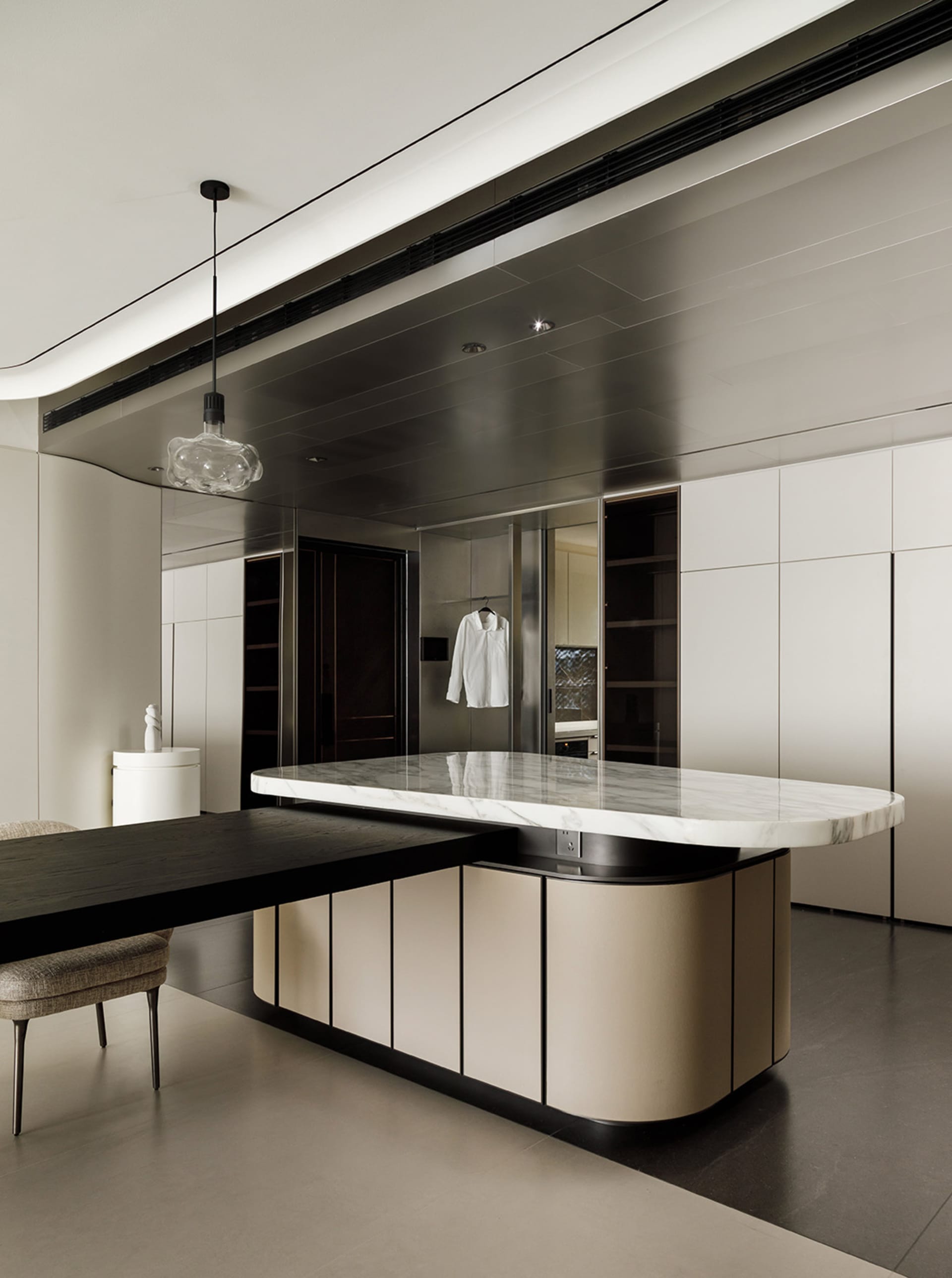 A modern minimalist kitchen featuring marble countertops.