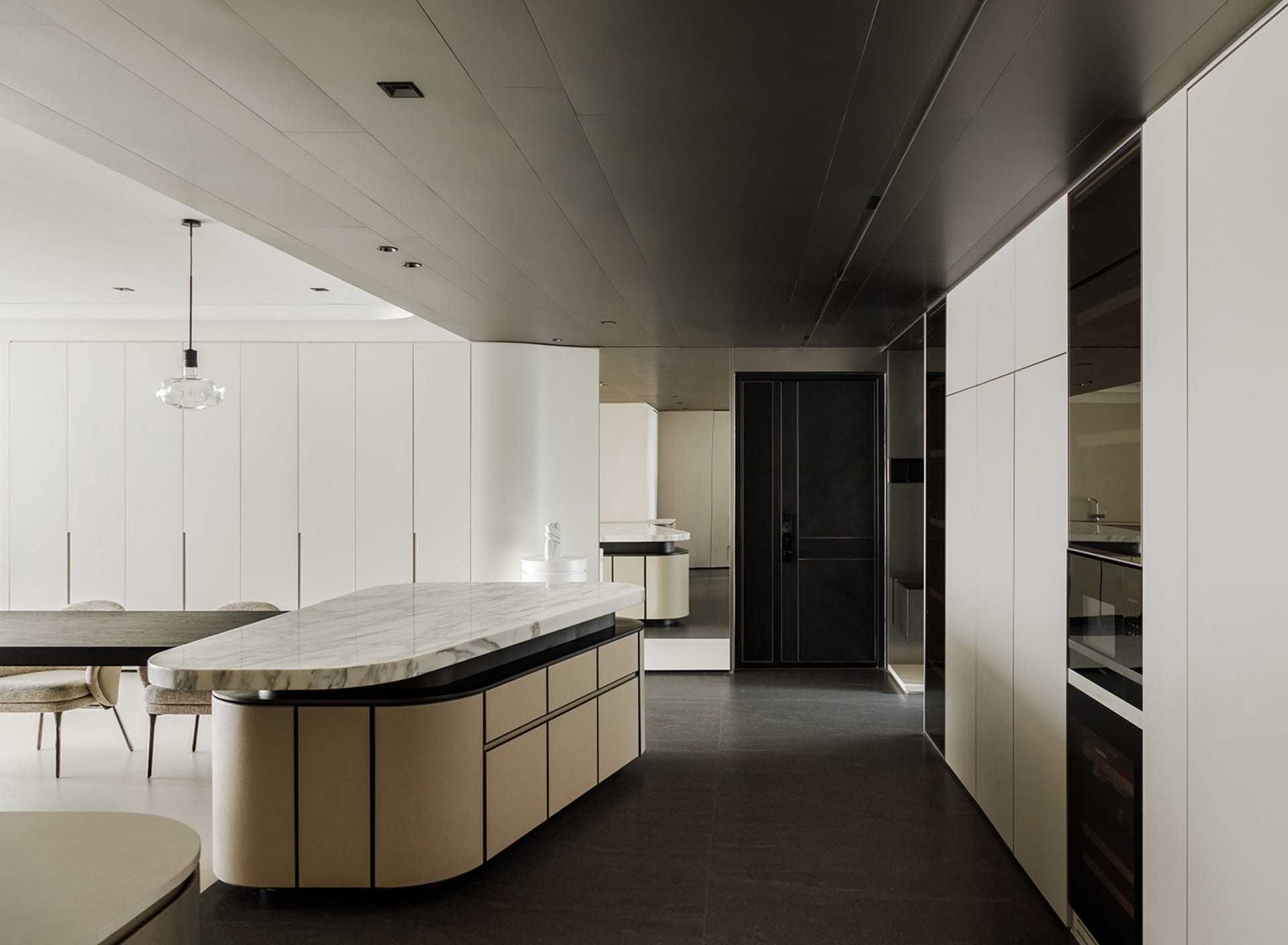 Modern residential kitchen featuring a striking marble countertop and minimalist design elements.