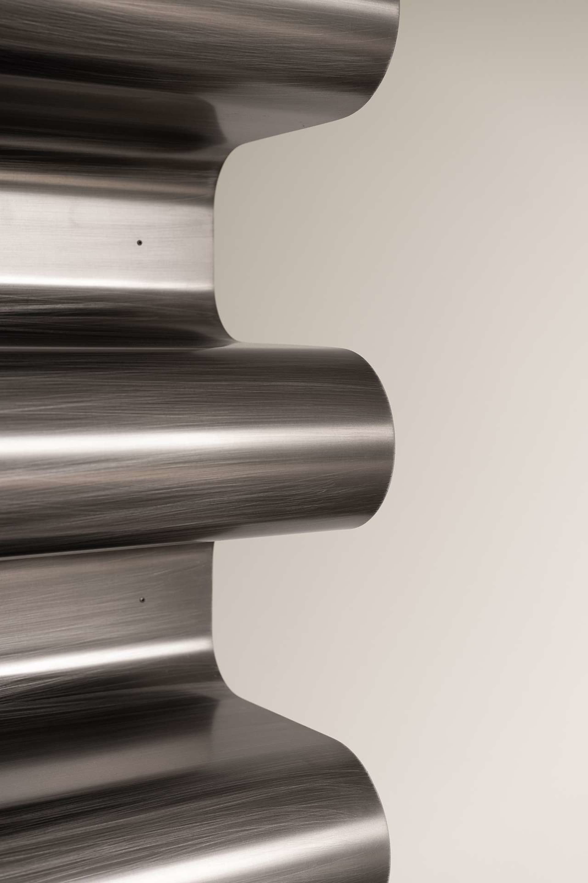 Linear metal staircase with curved steps.