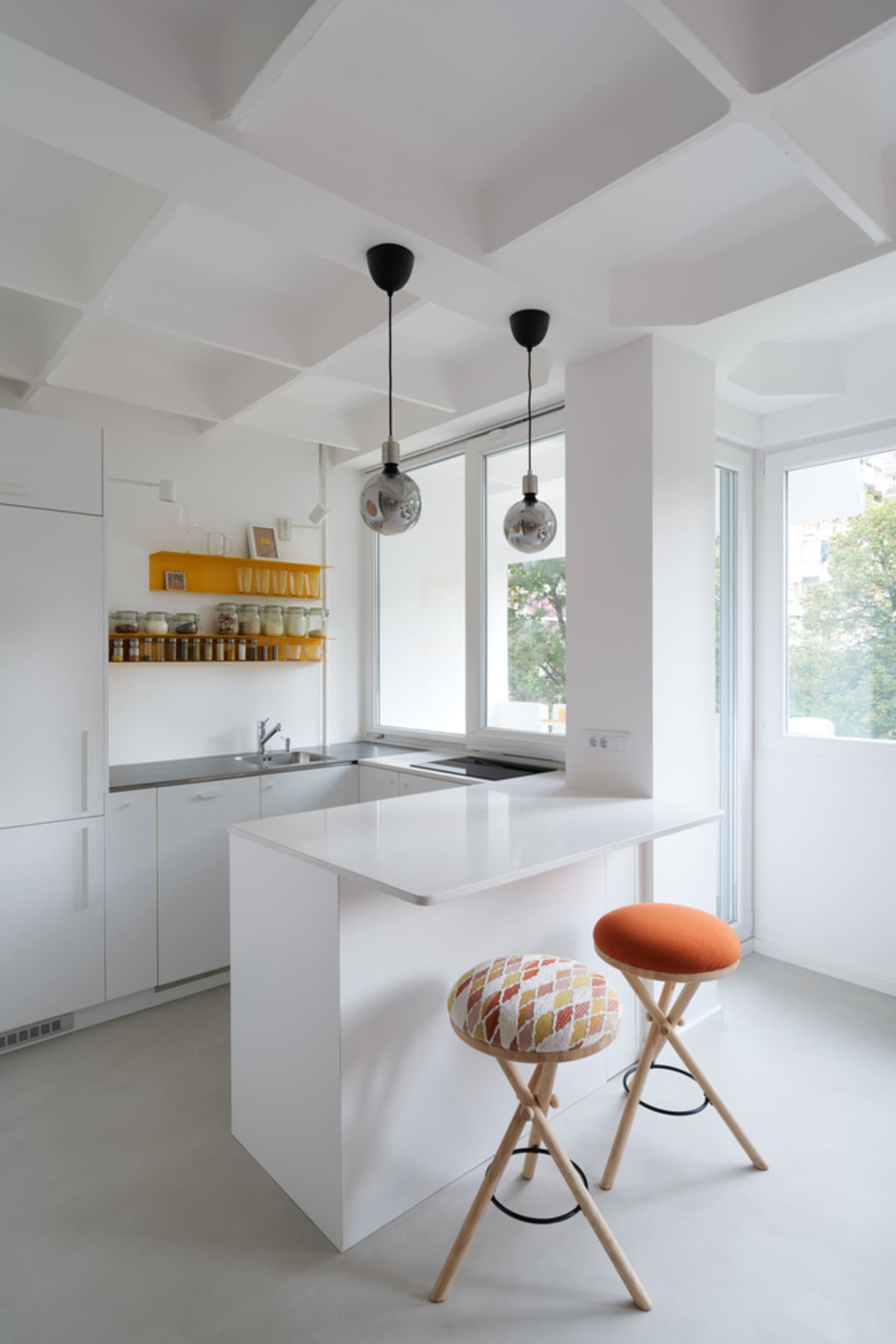 White, minimalist kitchen with a modern design.
