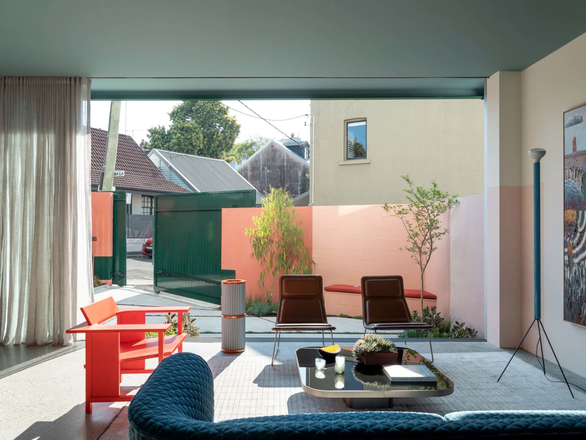 A contemporary living room featuring modern furniture, colorful walls, and a combination of materials.