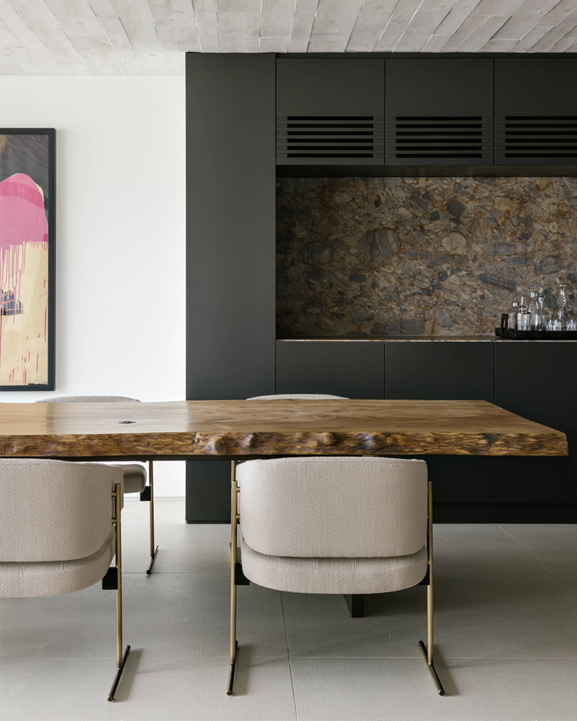 Modern dining room featuring a wooden table and metal chairs.
