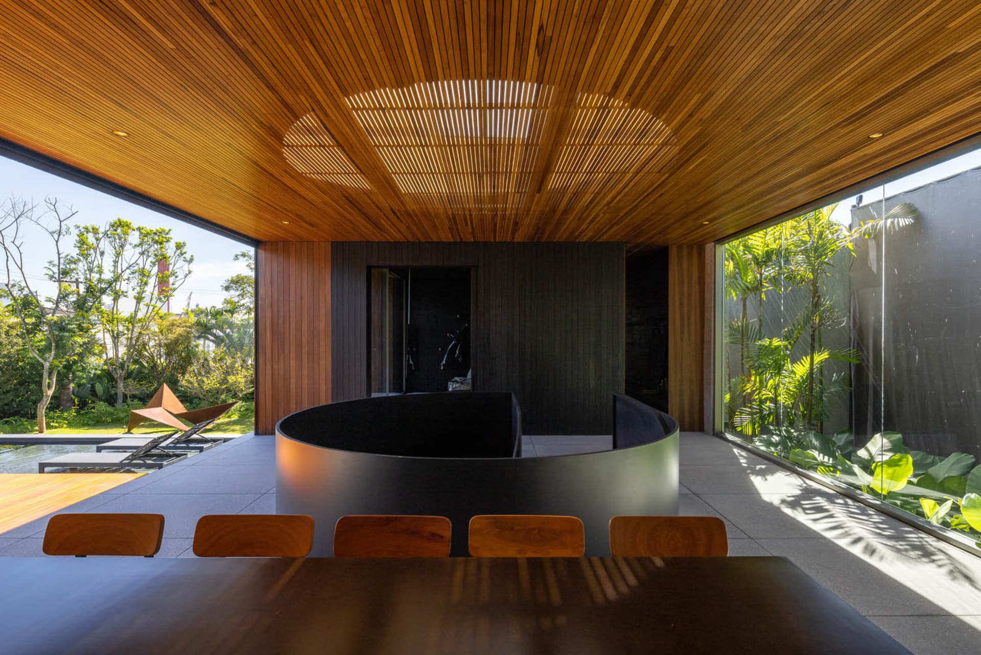 A modern interior space featuring wooden walls and concrete elements.