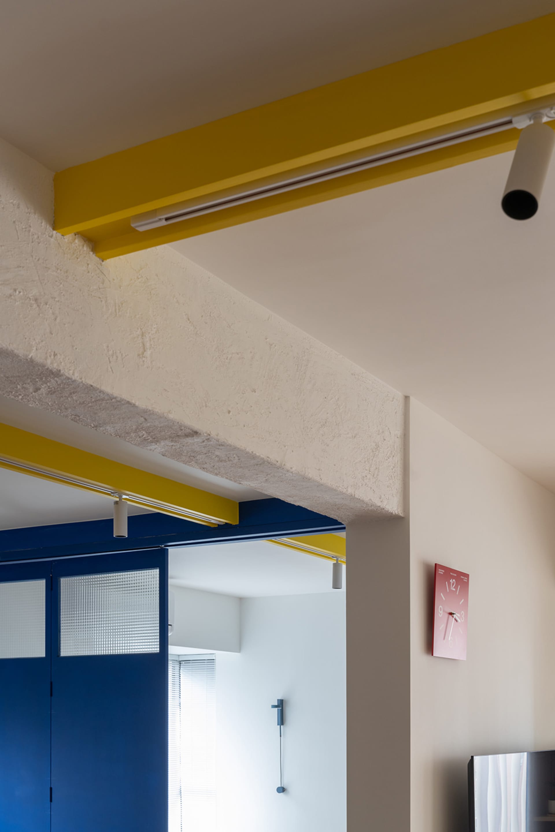 Modern residential entryway with concrete, metal, and glass elements.