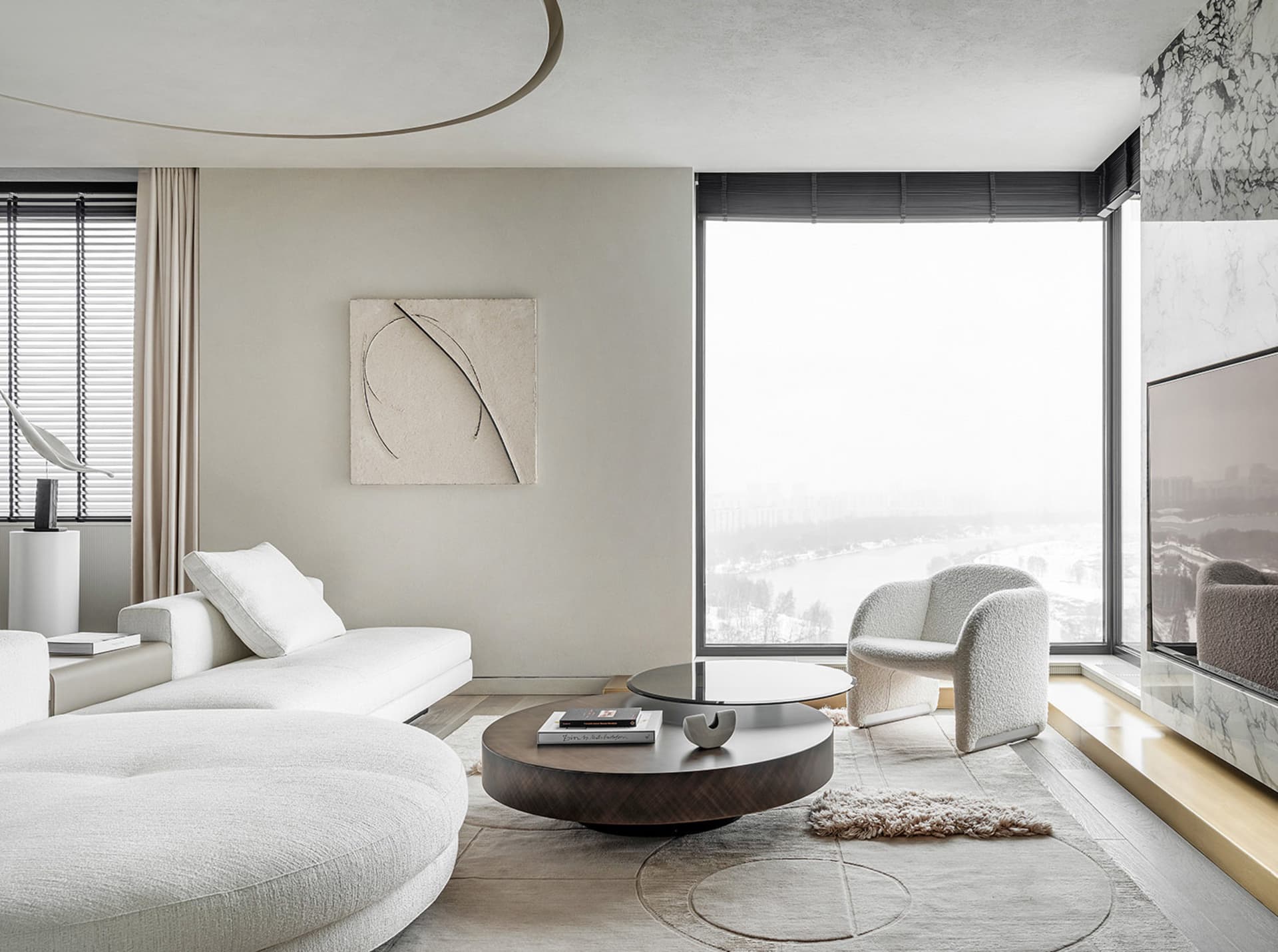 Modern living room with white textured fabric furniture, marble accents, and wooden flooring.