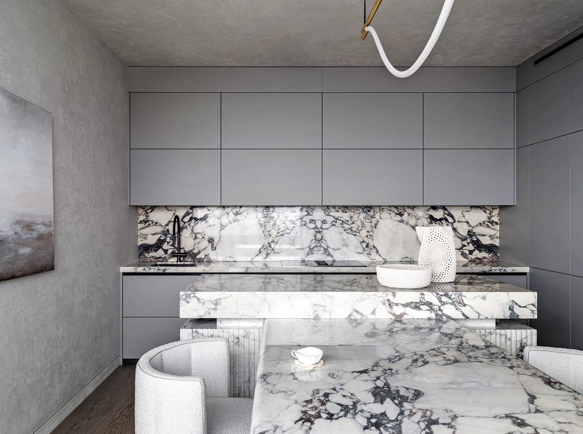 Modern, minimalist kitchen with marble countertops and backsplash, featuring sleek grey cabinetry and a contemporary interior
