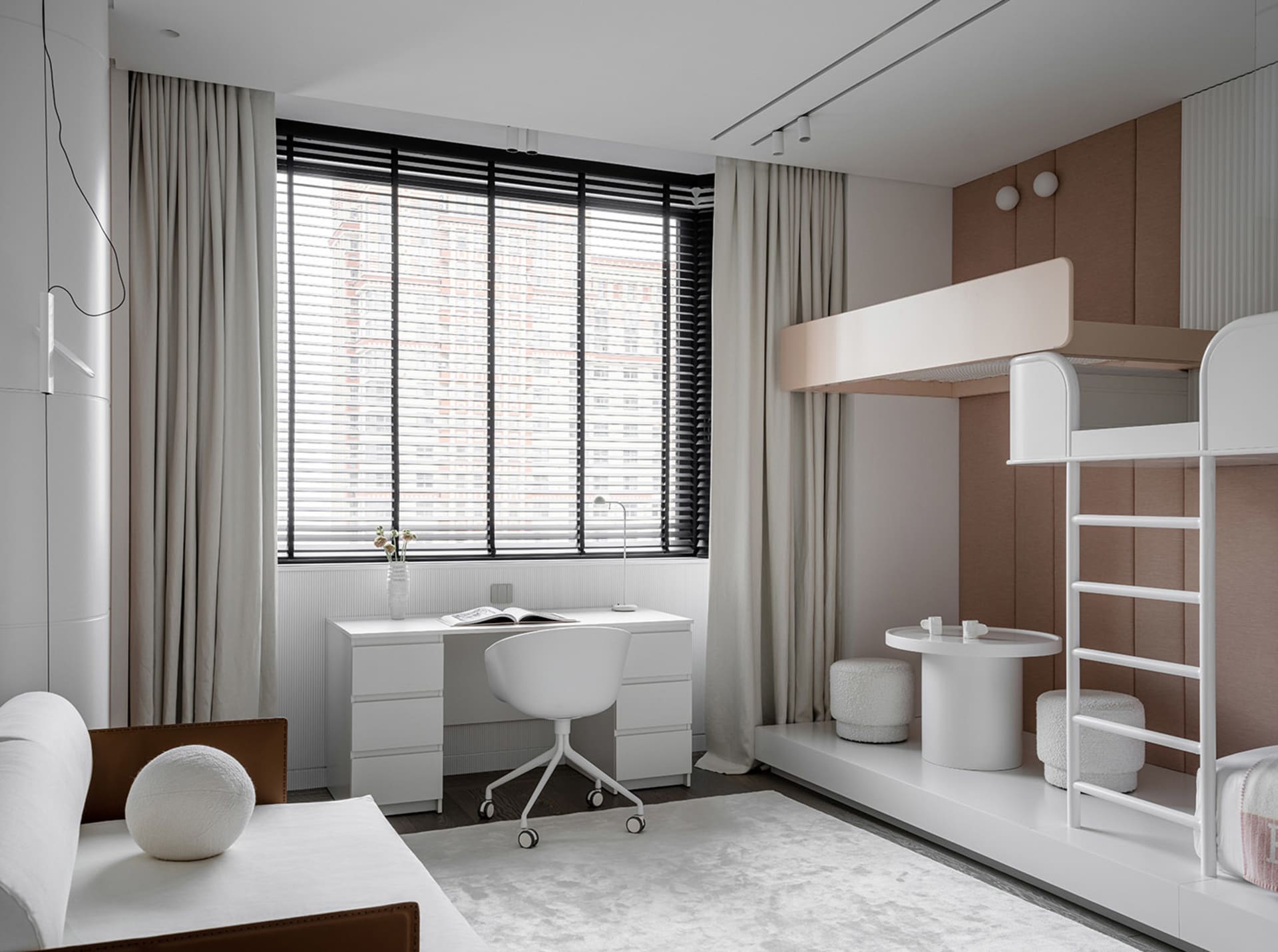 A modern home office space featuring a minimalist design with neutral colors, a desk, and a comfortable seating area with a b
