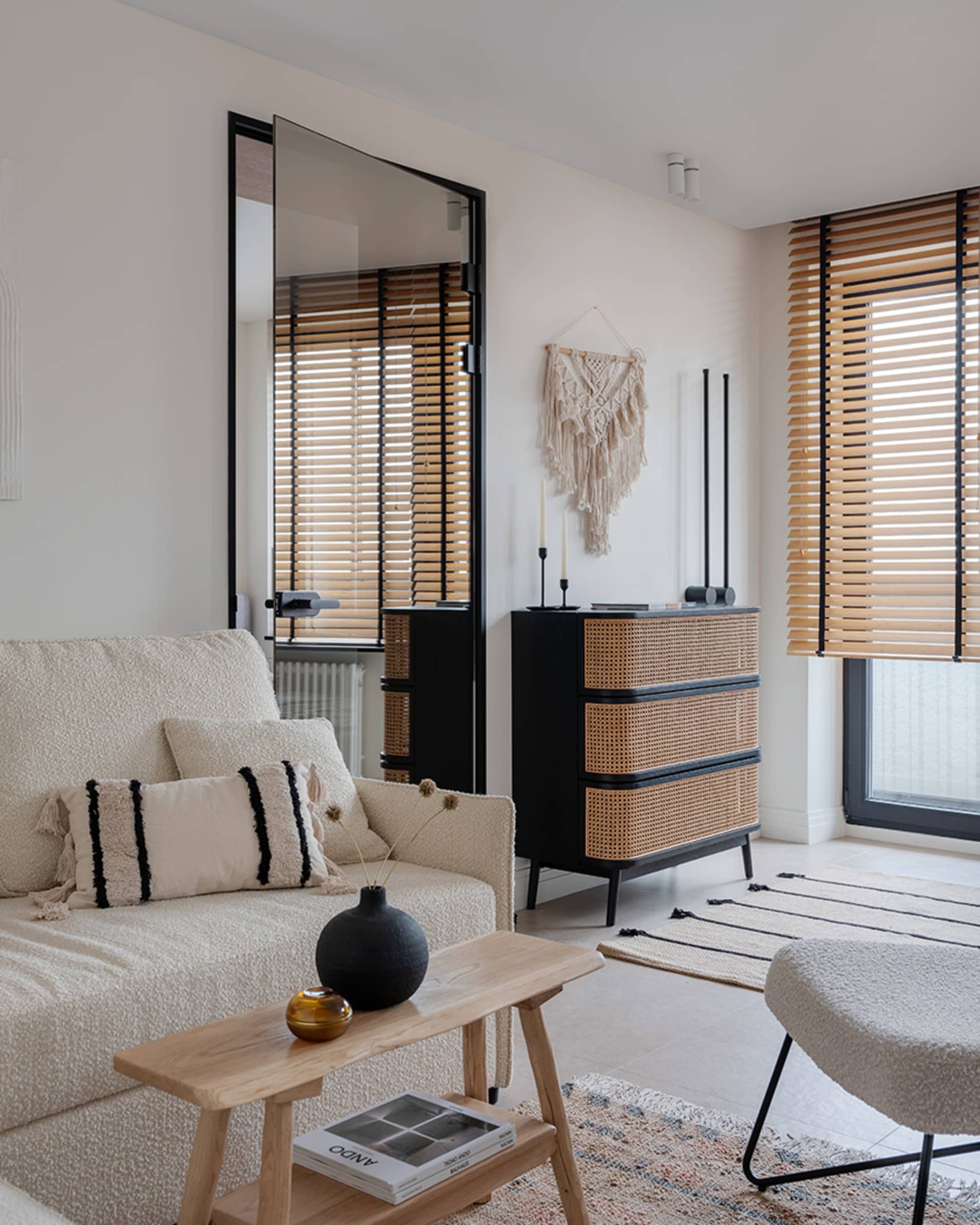 A minimalist living room featuring neutral-toned furniture and decor.
