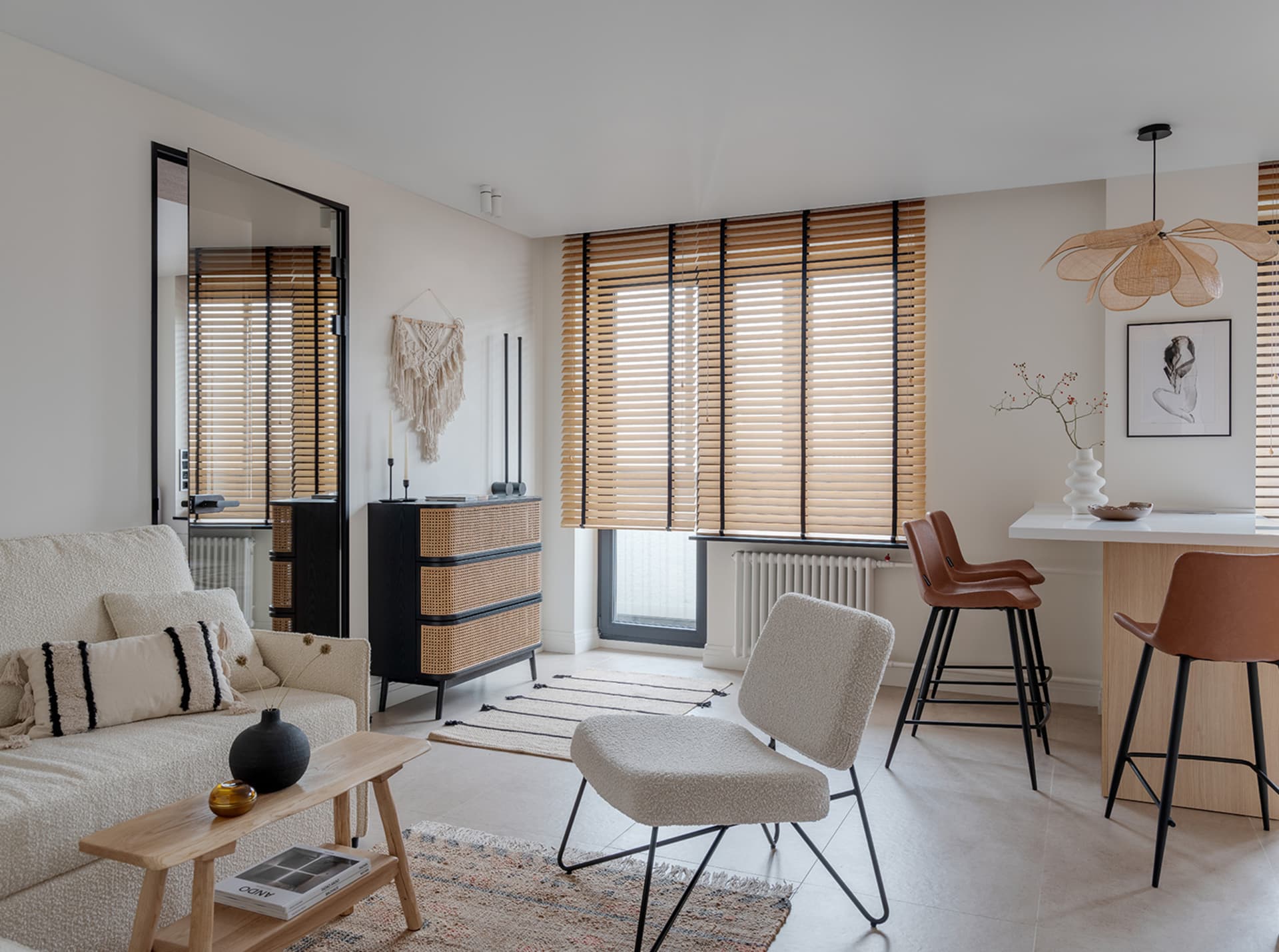 A minimalist living room featuring wood furnishings and fabric accents.