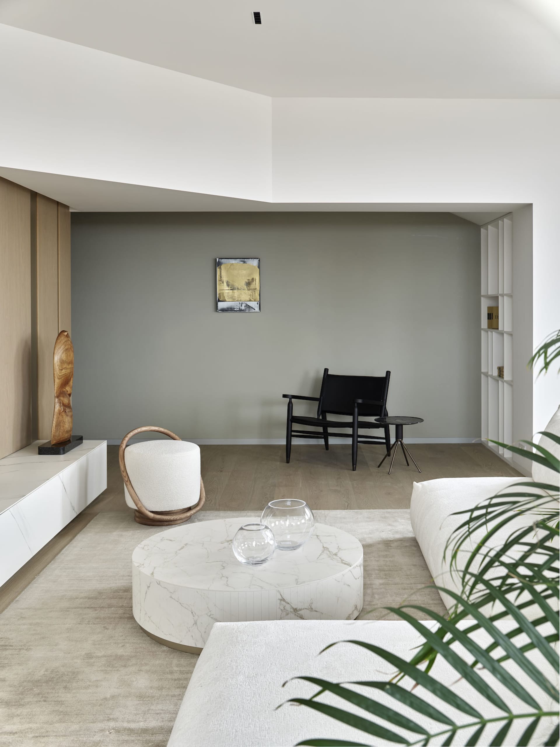 A minimalist living room with marble furniture and white decor.