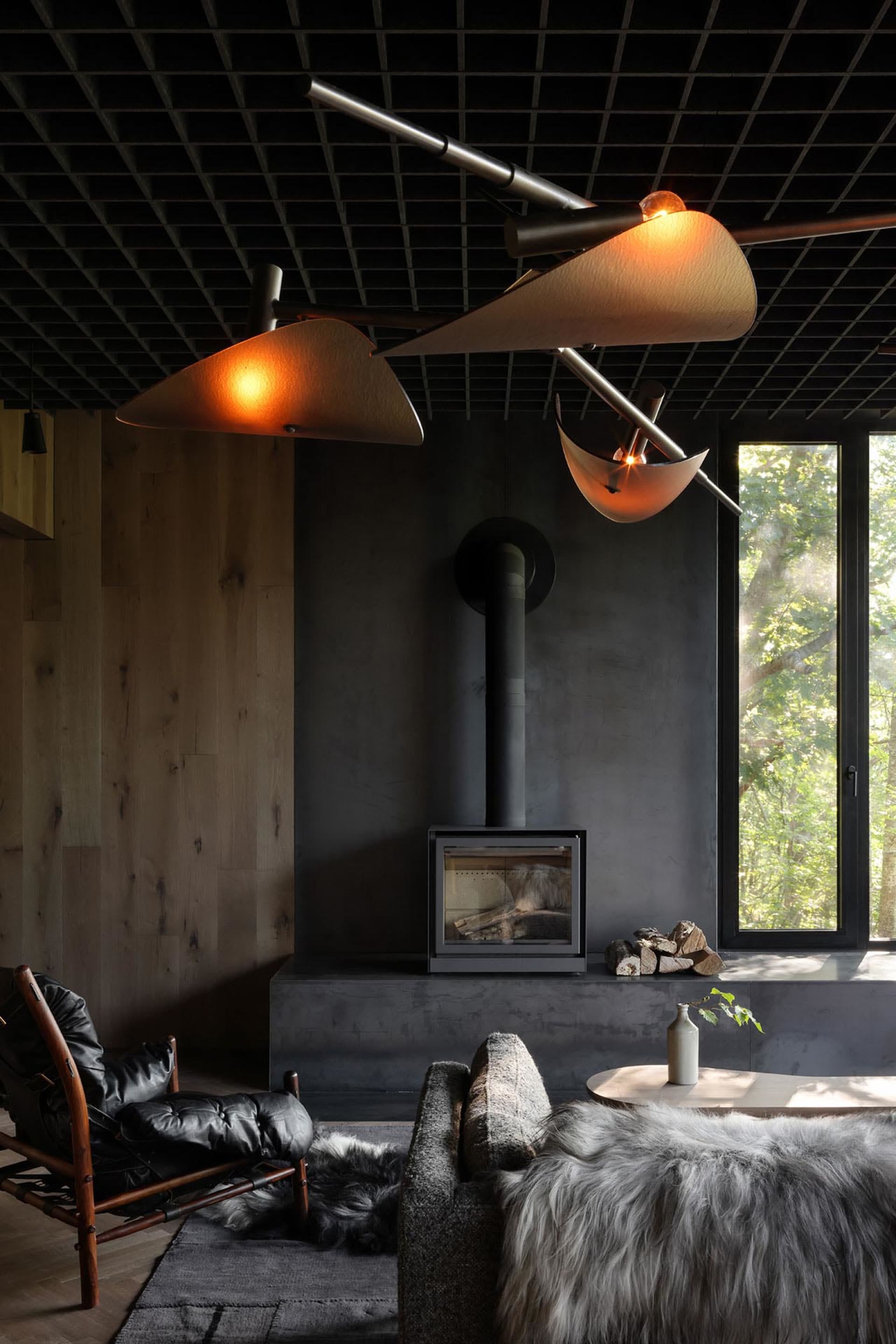 Industrial-style living room featuring concrete surfaces, minimalistic design, and a cozy fireplace.