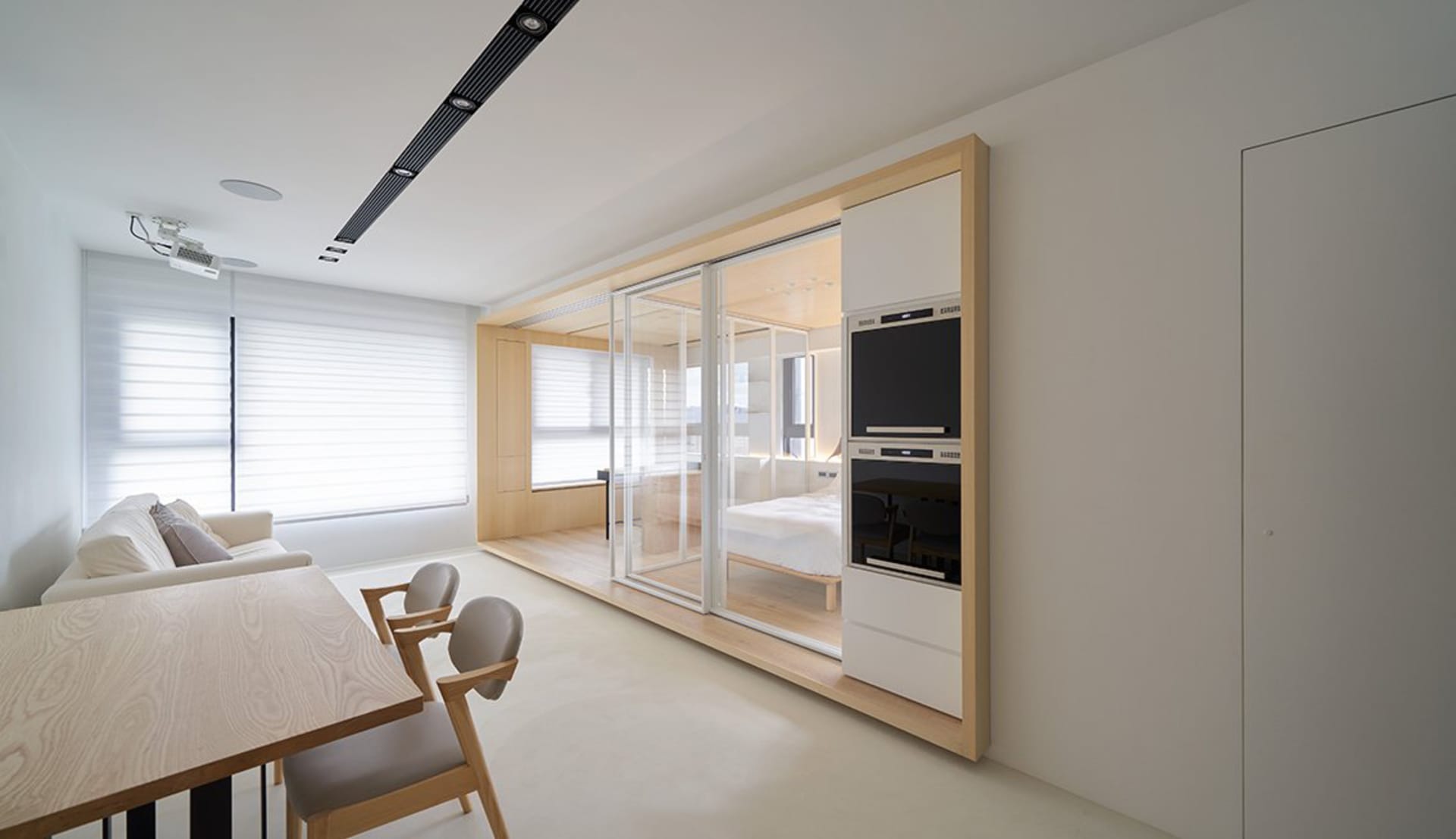 White minimalist residential interior with glass and wooden furniture.