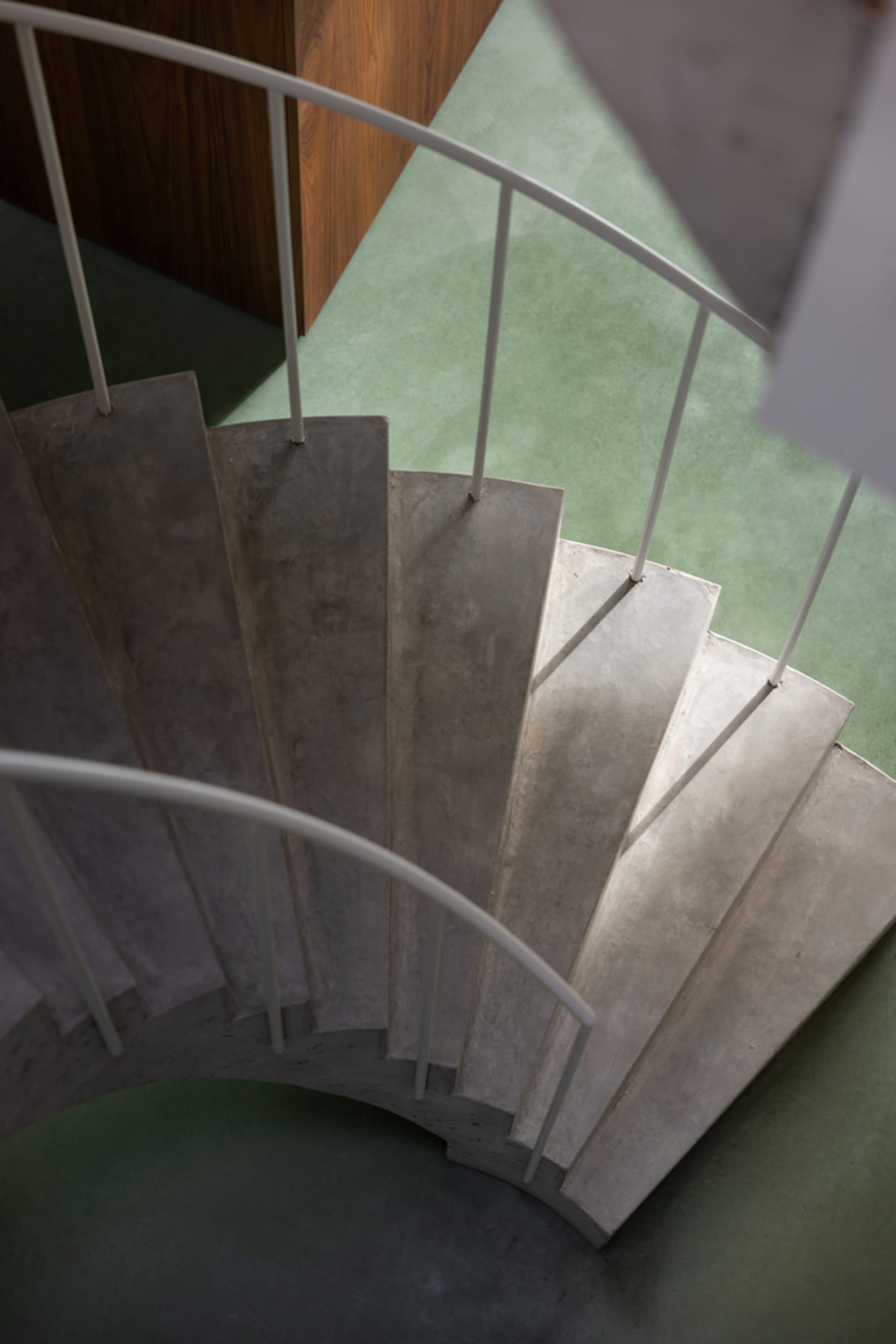 Concrete staircase with minimalist design elements, featuring smooth, clean lines and a modern aesthetic.