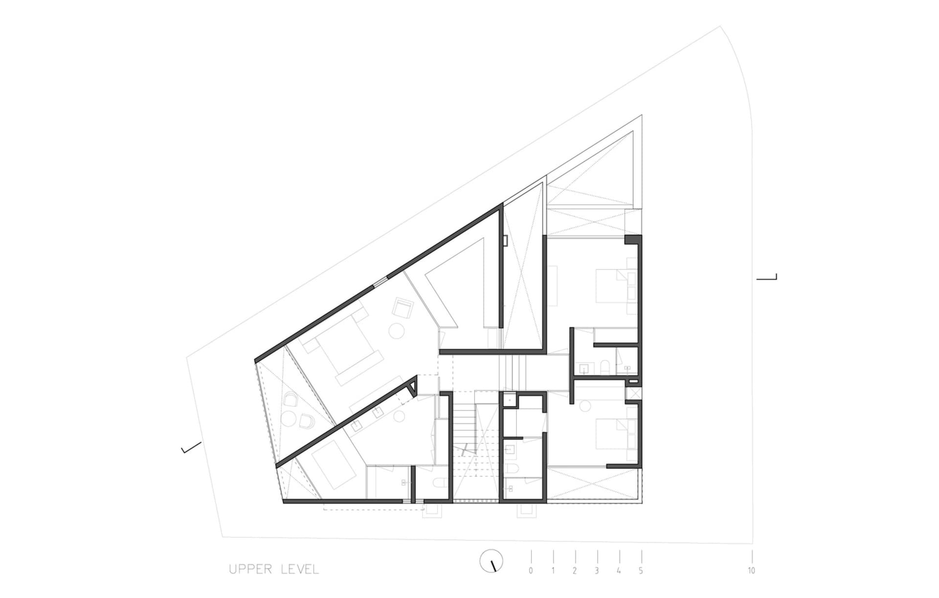 Floor plan of a modern upper level with furnished rooms and architectural details.