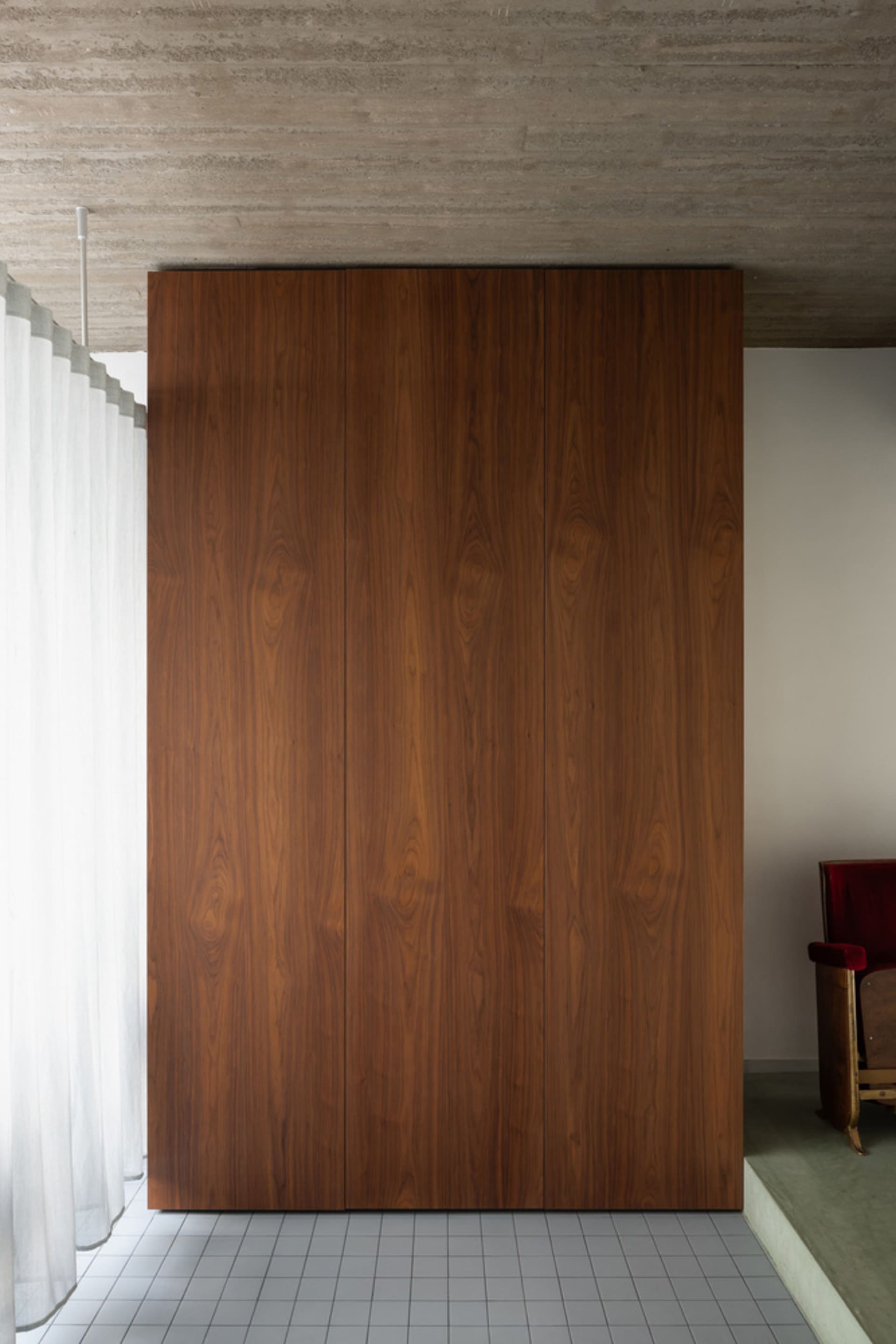 Modern cabinetry with sleek wooden surfaces in a minimalist interior setting.