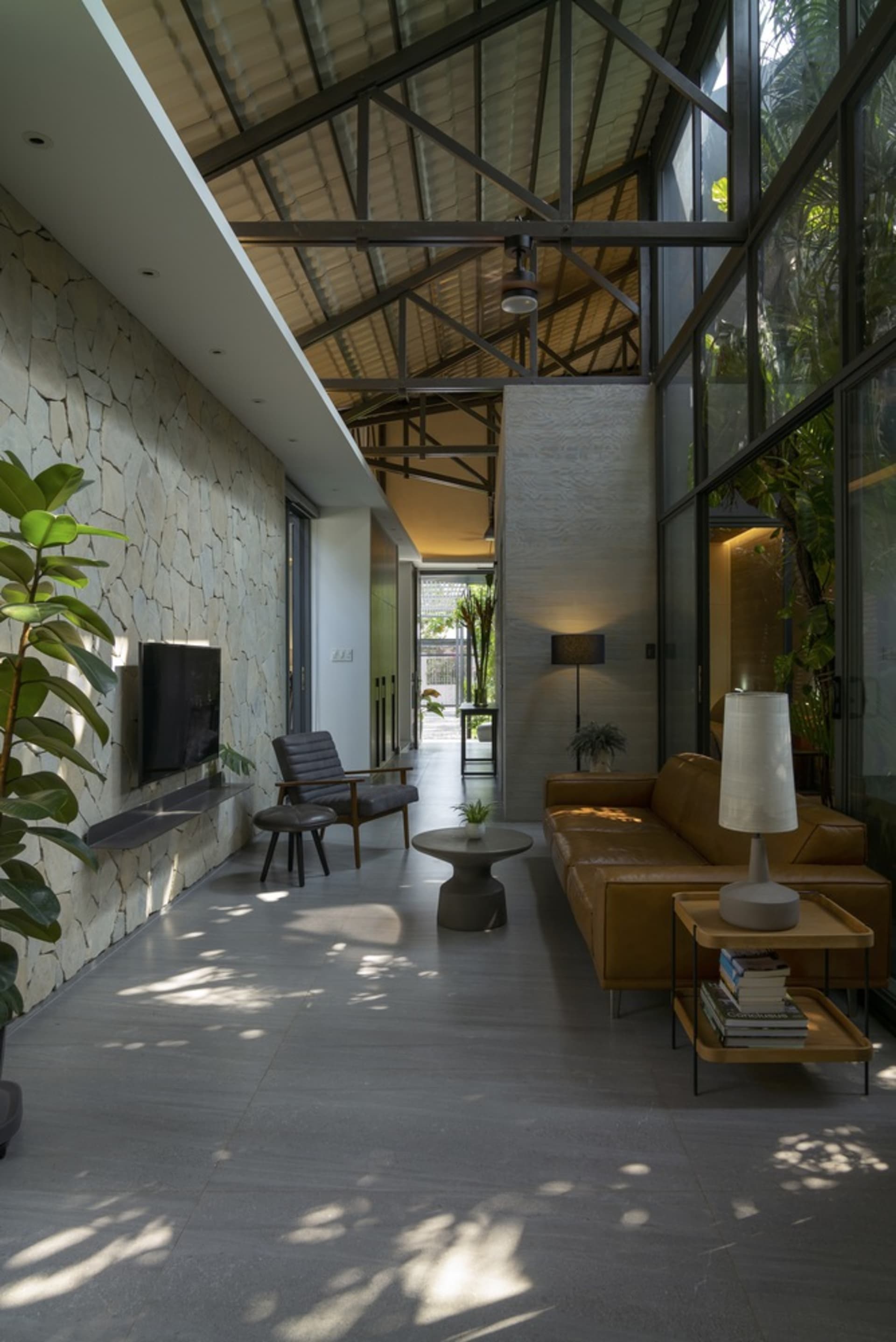 A modern living room featuring concrete, wood, and glass materials.
