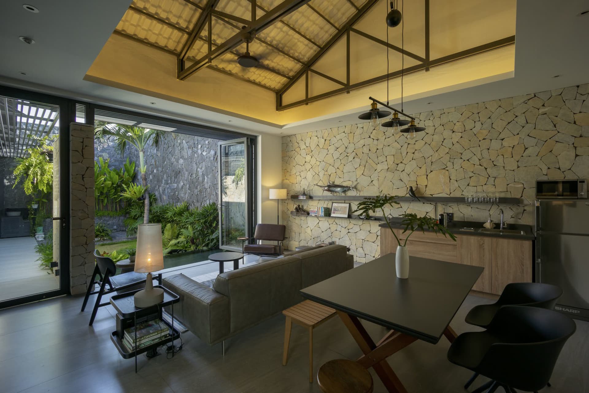 A modern living room with a stone accent wall and open concept design.