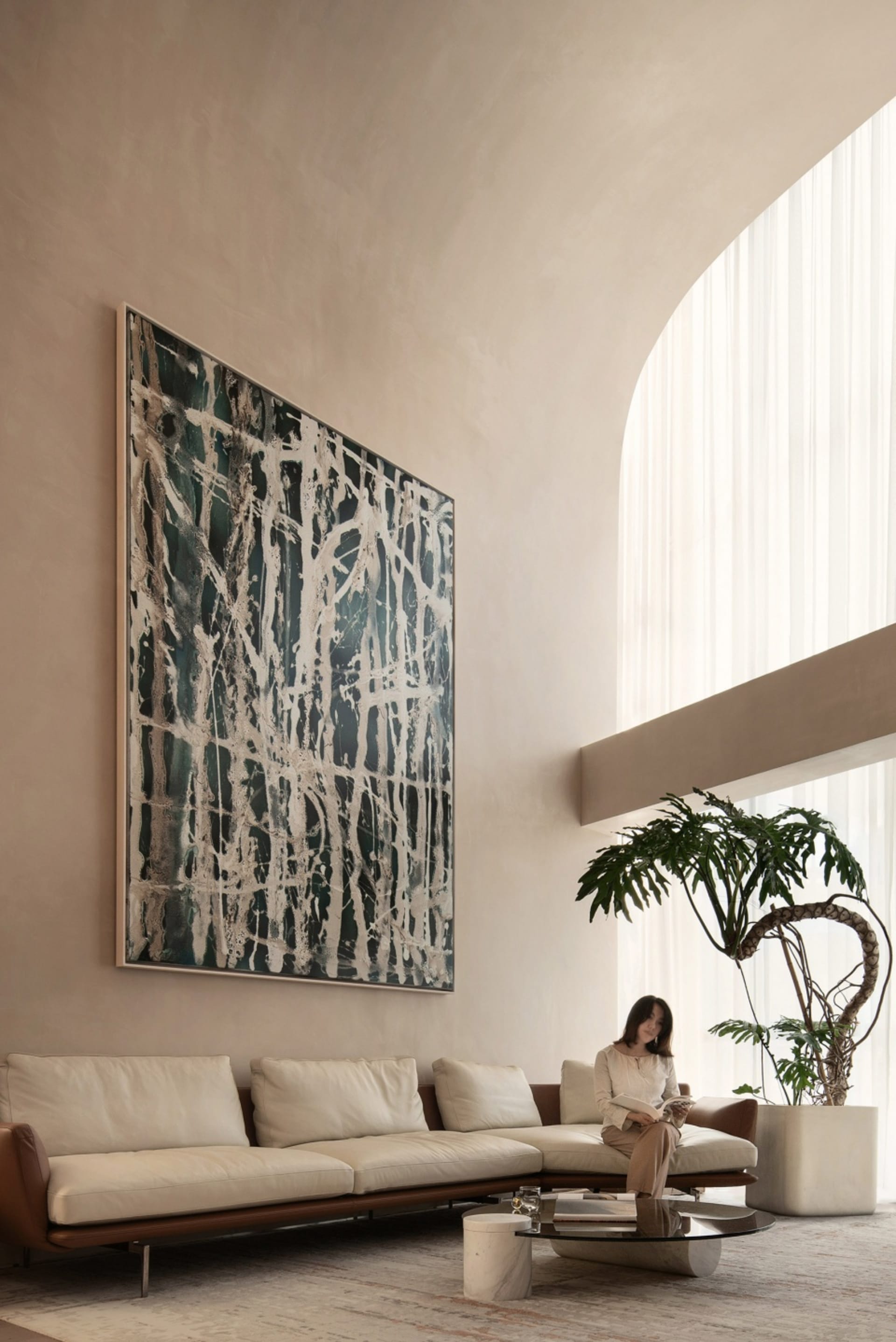 A contemporary living room with metallic furniture and large windows.