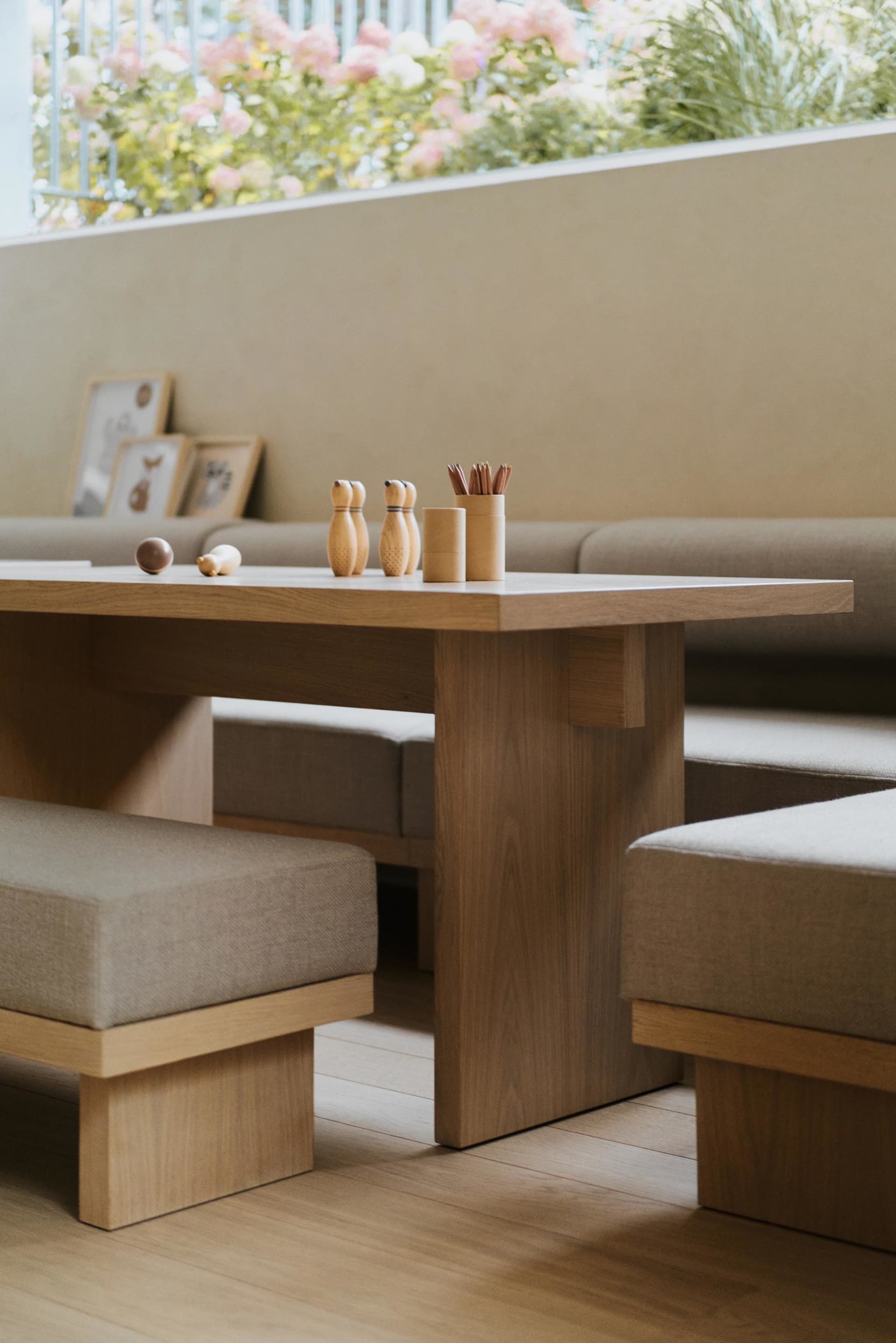 A modern living room featuring wooden furniture and seating.