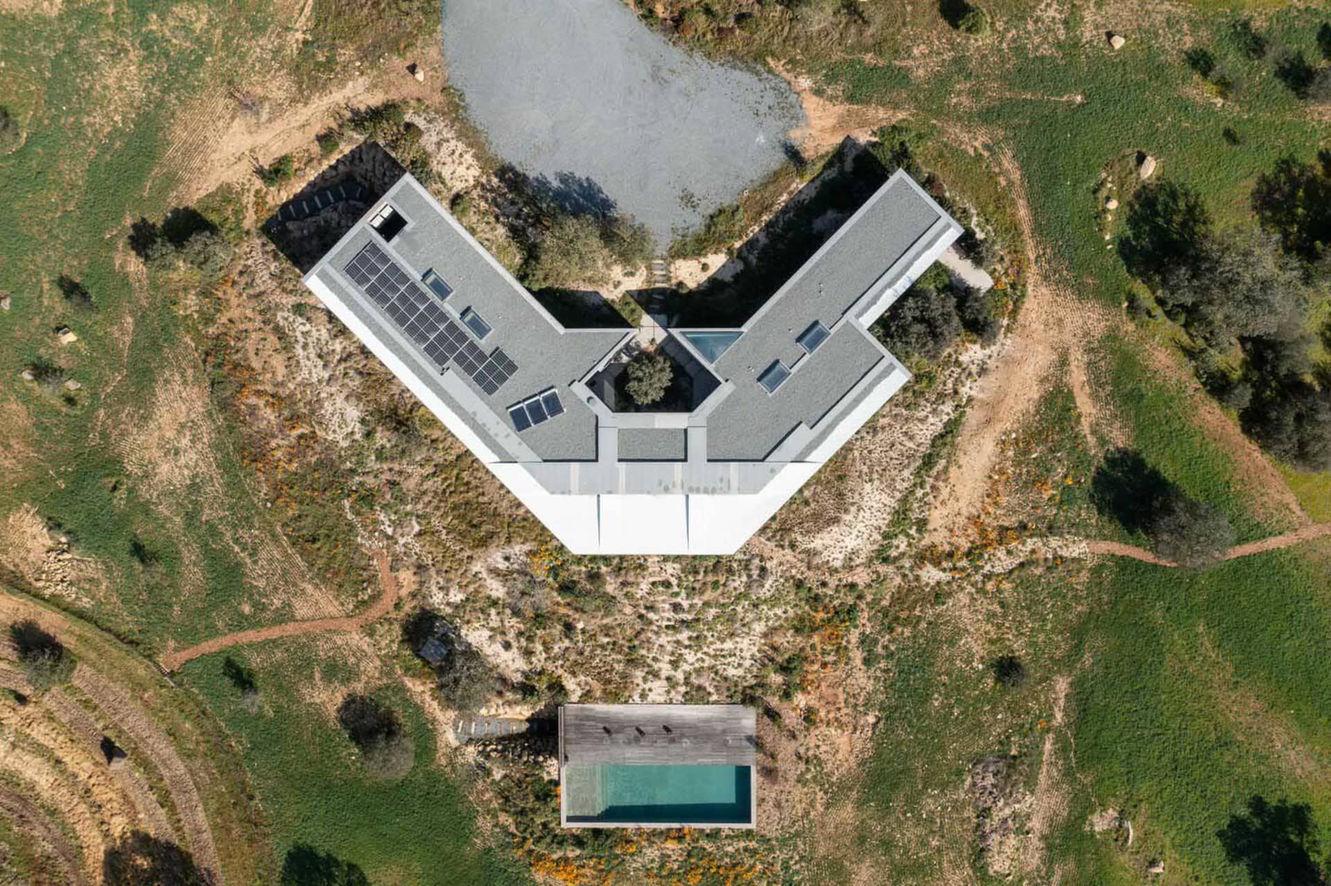 Aerial view of a modern residential building with a concrete exterior and geometric design.