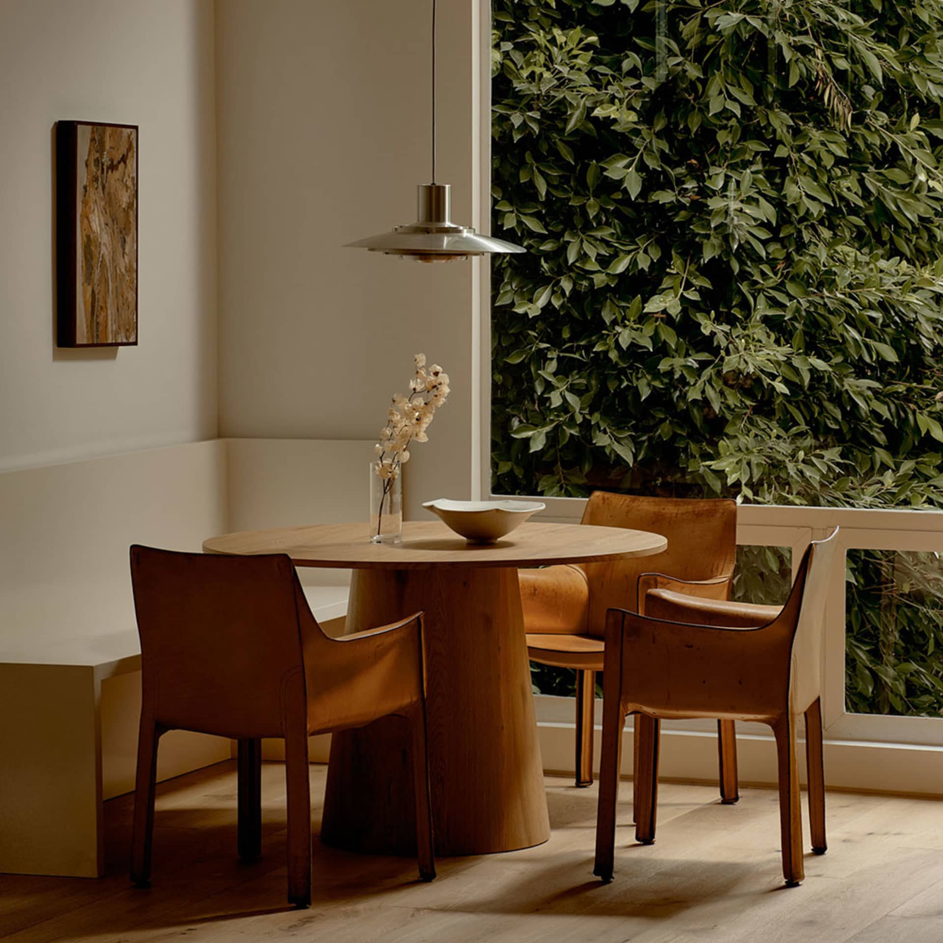 Industrial-style dining table and chairs in a residential setting.