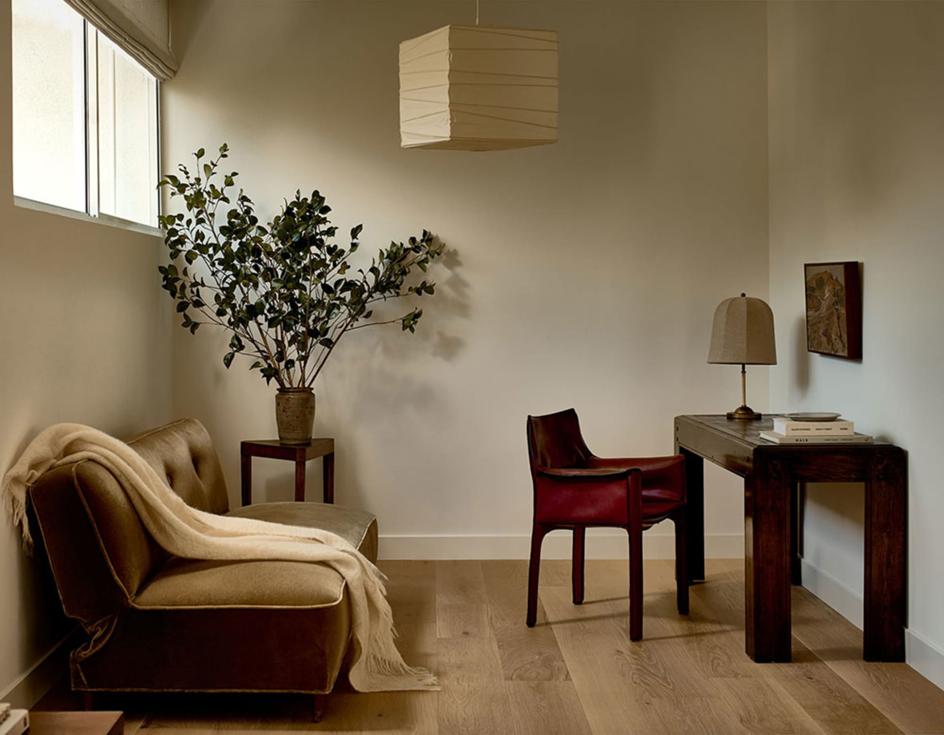 A modern living room featuring wooden furniture, fabric sofa, and leather chairs.