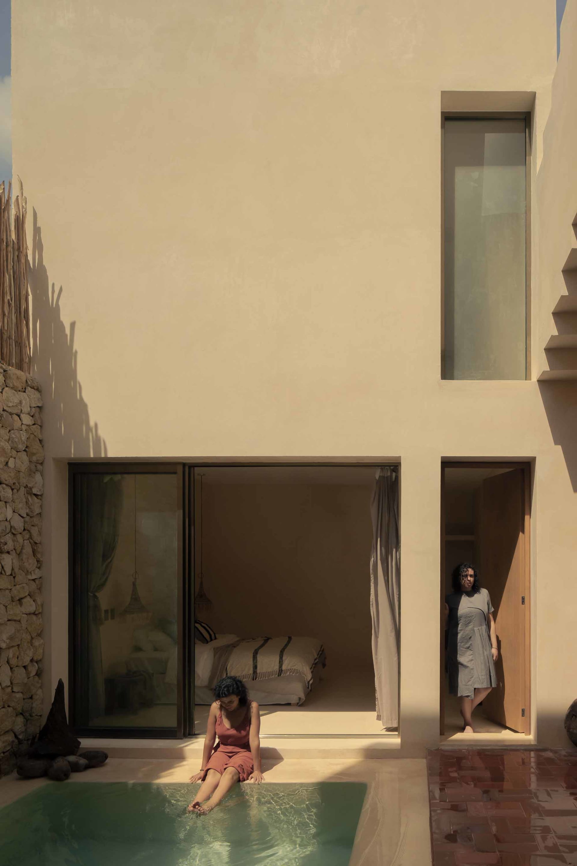 A minimalist house featuring a concrete pool.