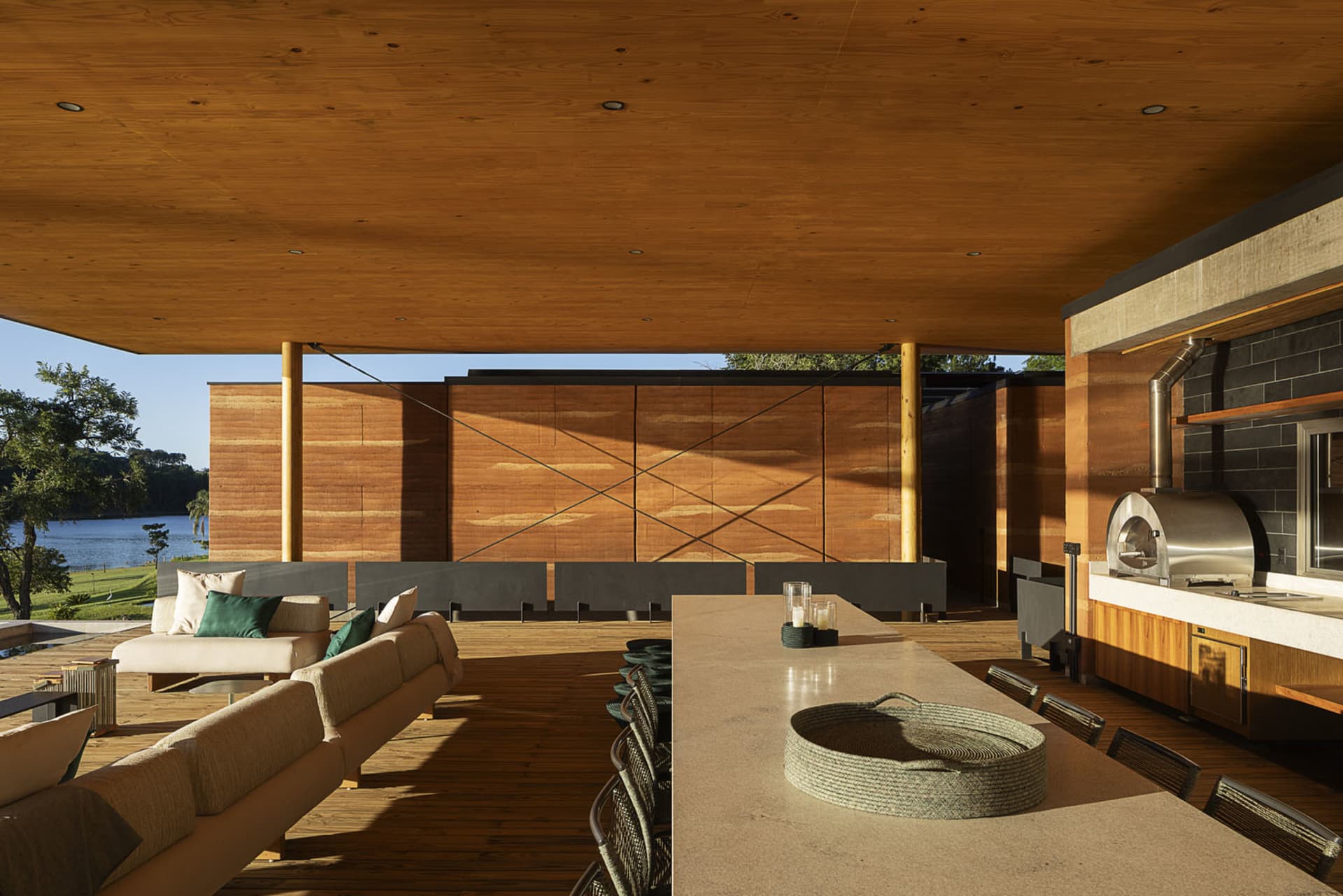 An outdoor residential patio featuring modern design elements and wooden surfaces.