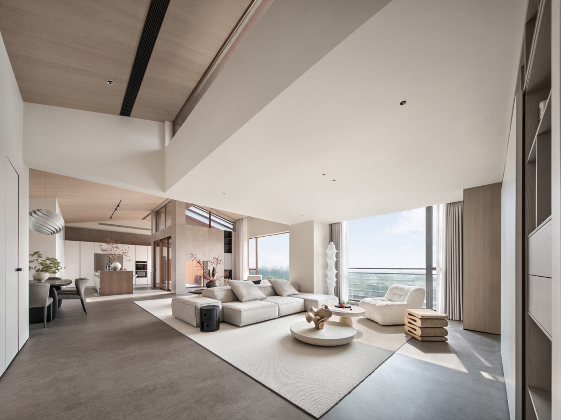 A modern living room with concrete flooring and minimalist design.
