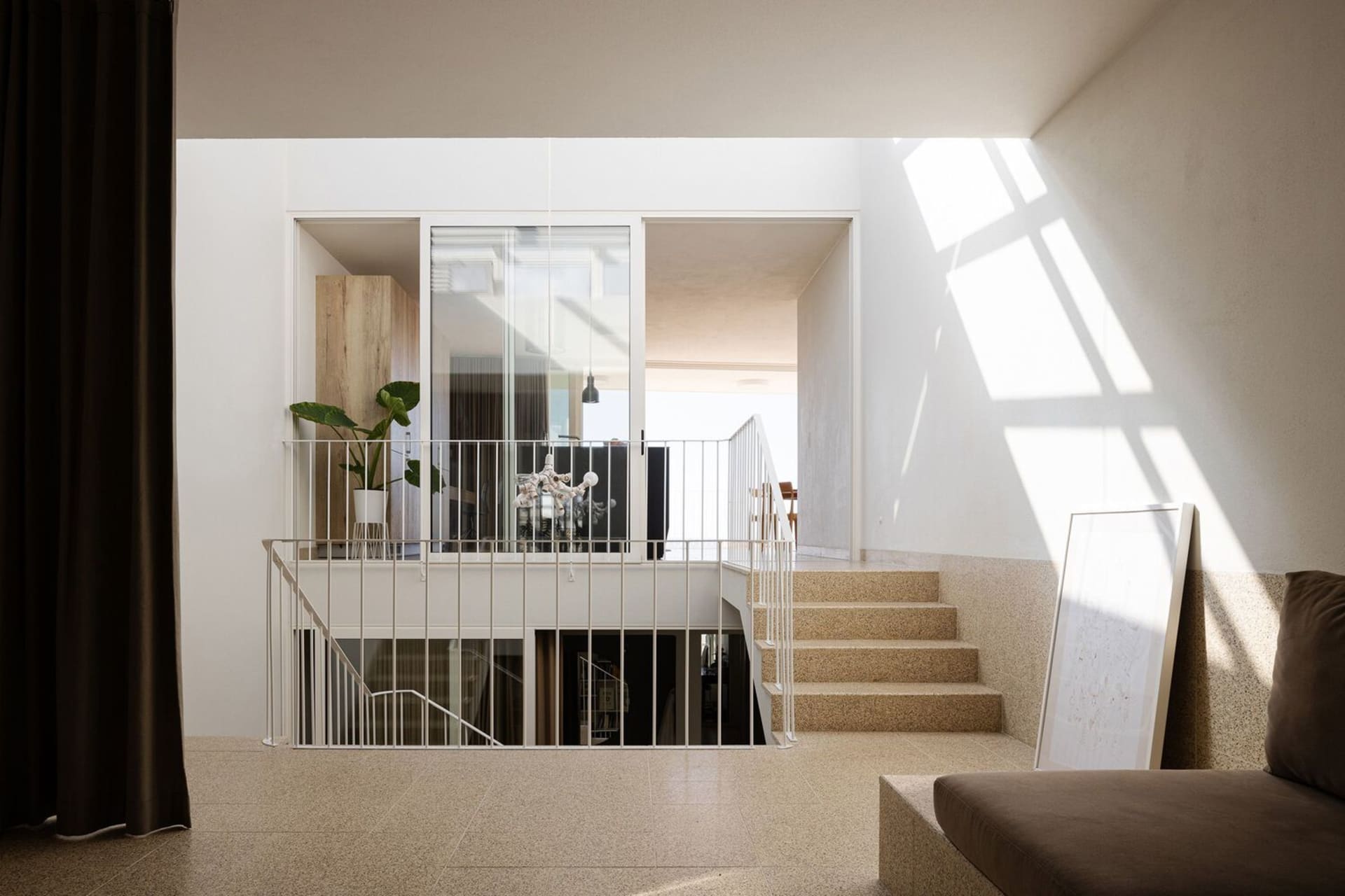 Modern interior space with concrete floor, glass walls, and minimalist design.