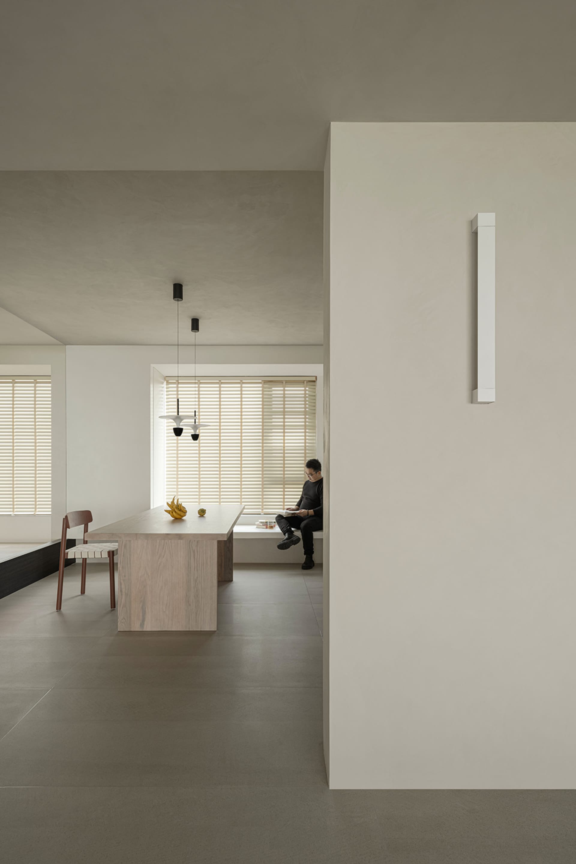 A minimalist flat with concrete walls and flooring.