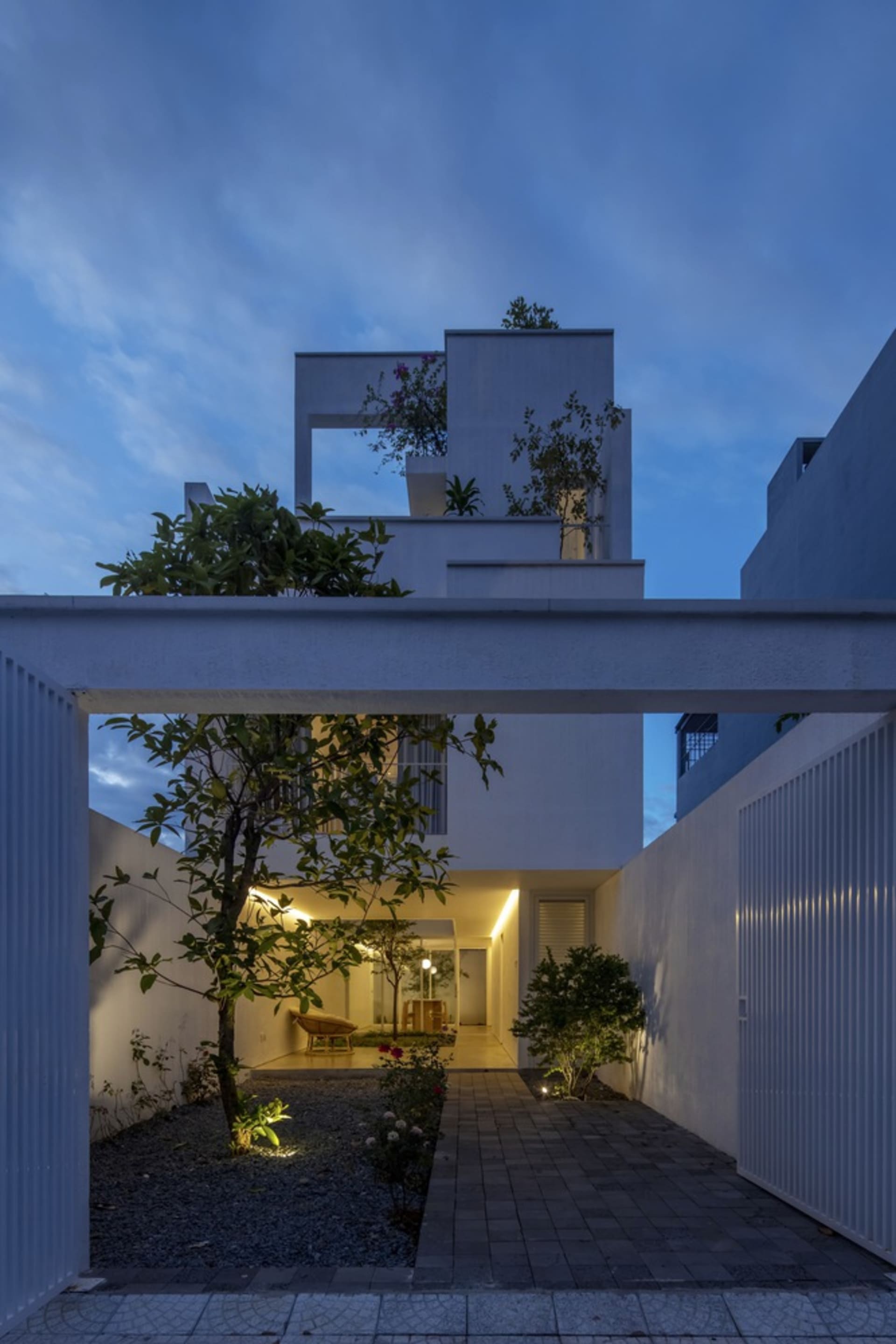 Modern residential house with concrete masonry exterior at dusk.