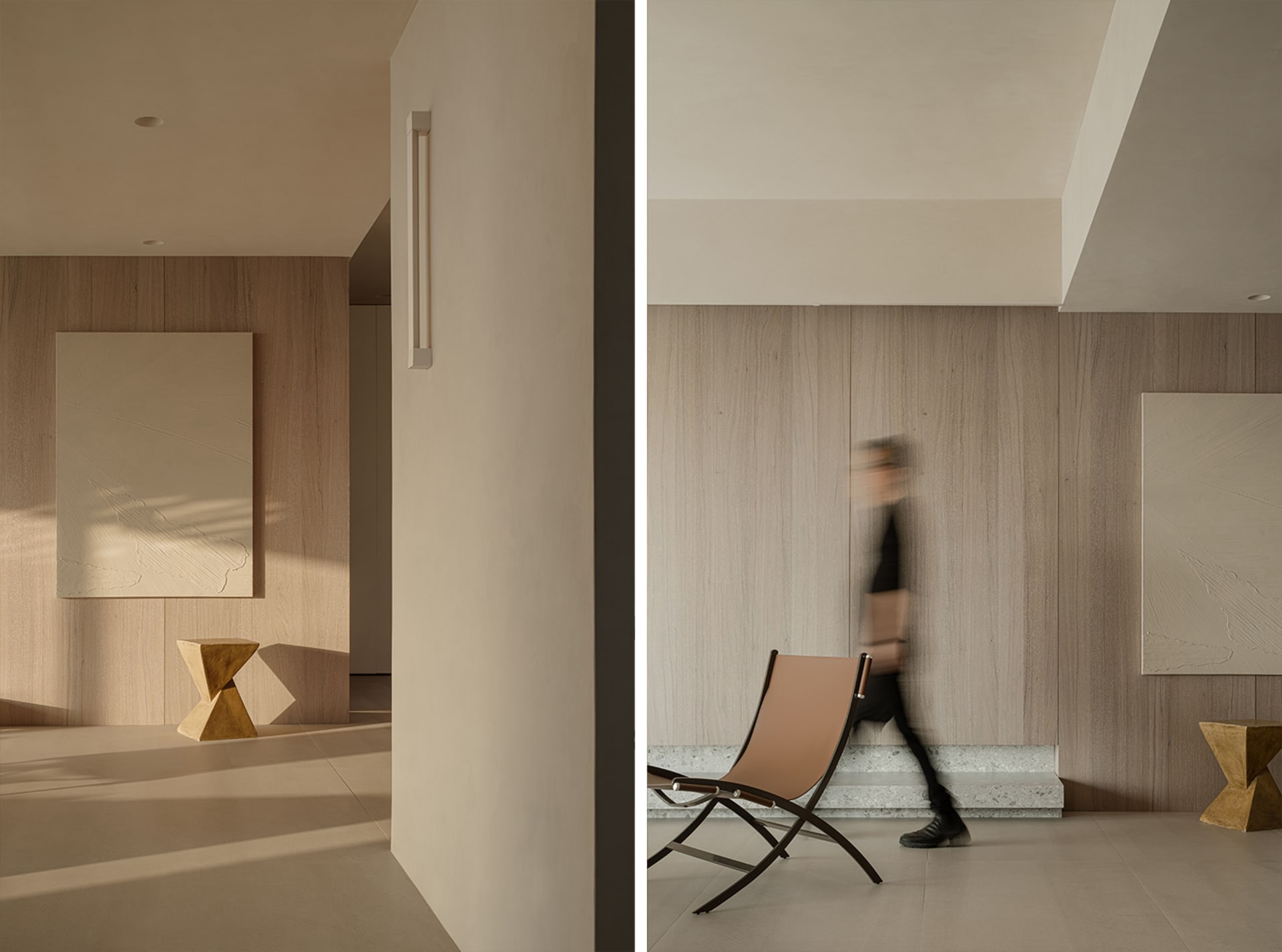 A modern living room featuring minimalist design with wooden walls, a beige chair, and abstract artwork.