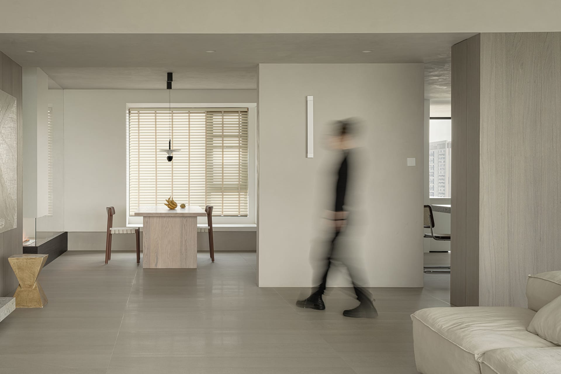 A modern minimalist living room with concrete and metal elements