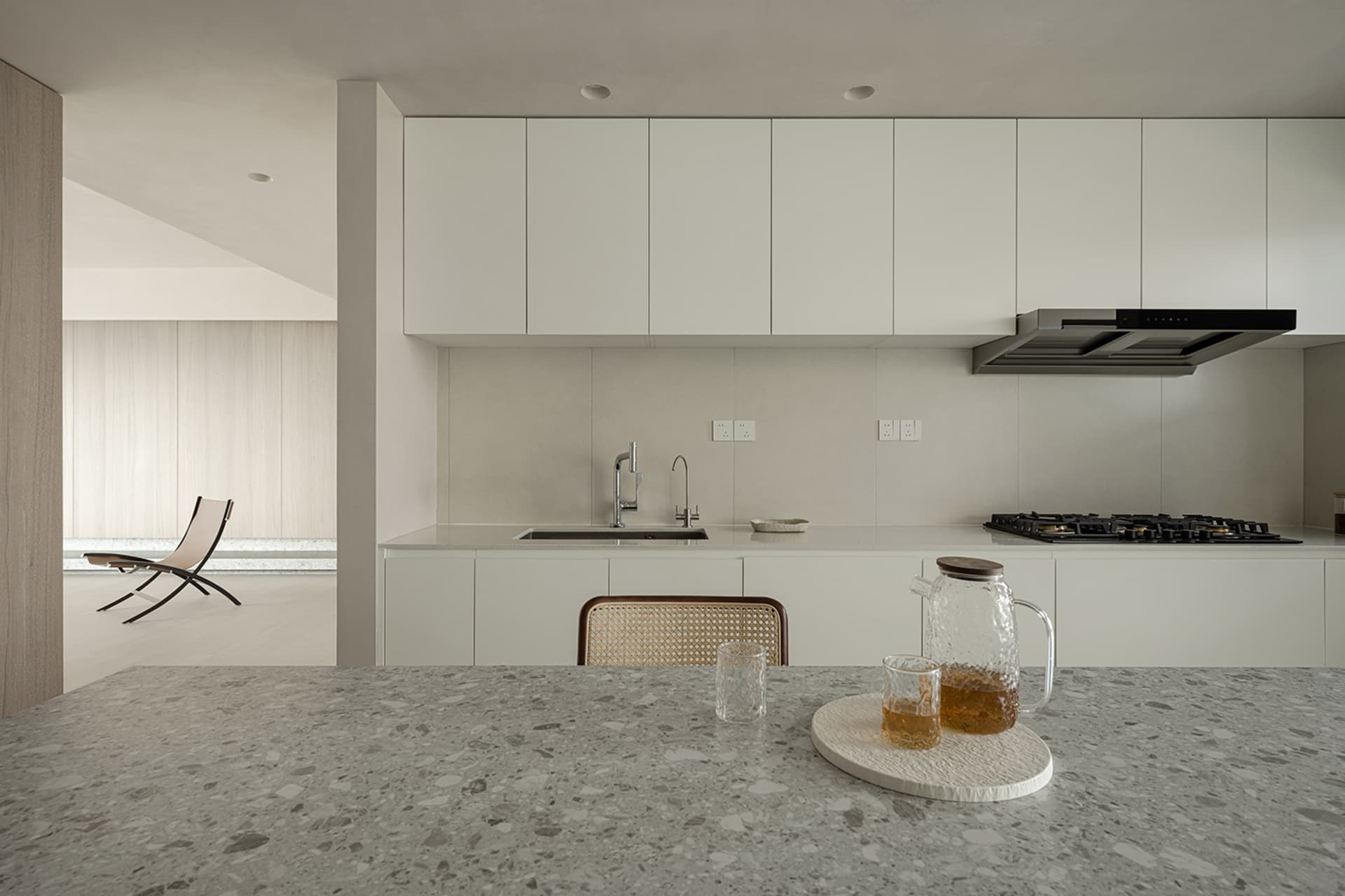 A minimalist residential kitchen featuring a concrete countertop.