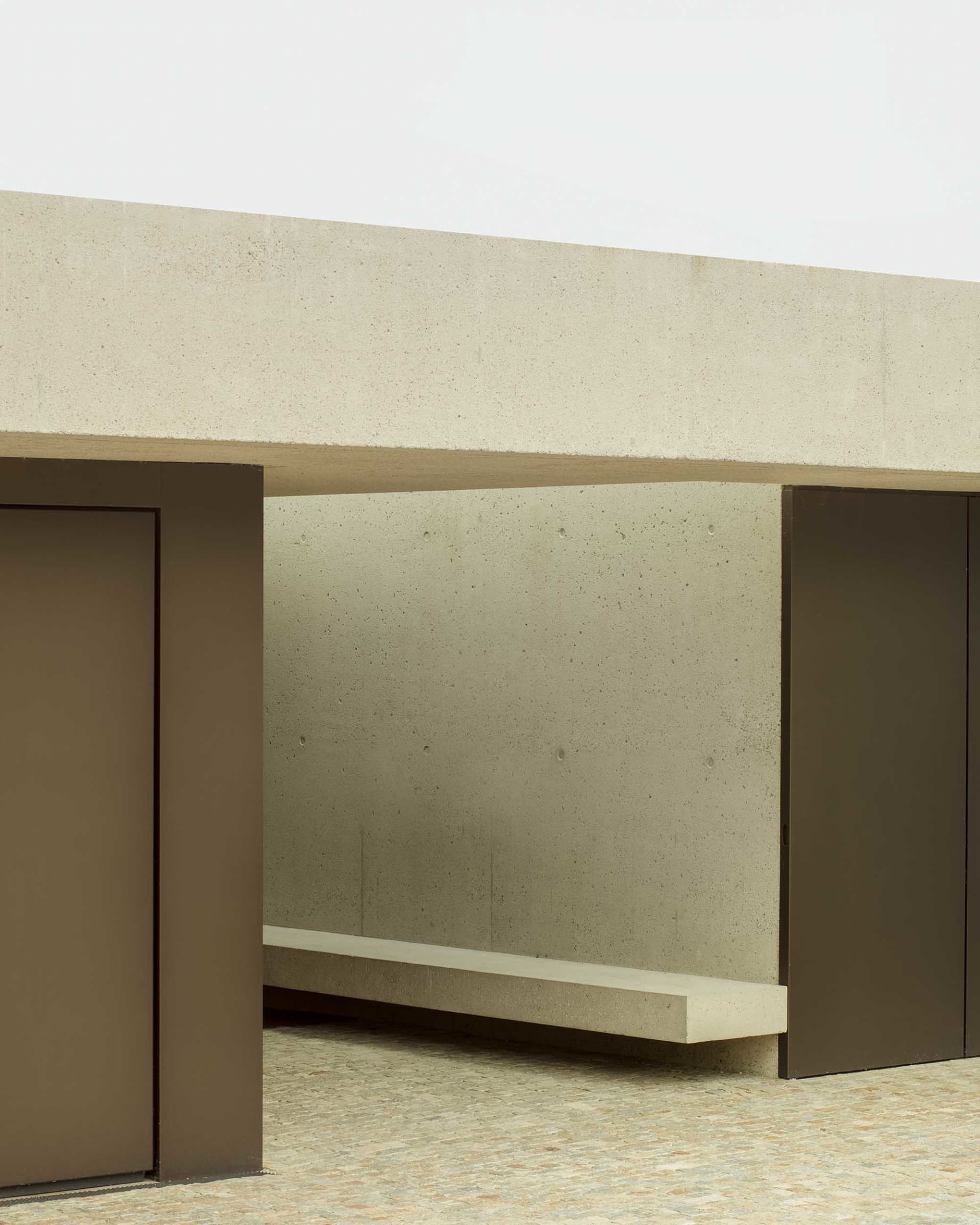 Modern minimalist architectural space featuring a concrete structure and minimalistic design elements.