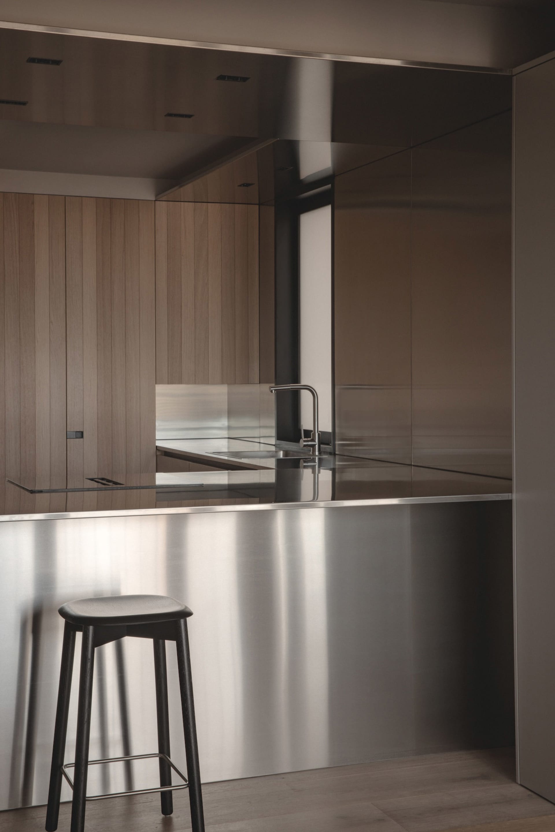 A modern kitchen featuring a metallic countertop and minimalist design.