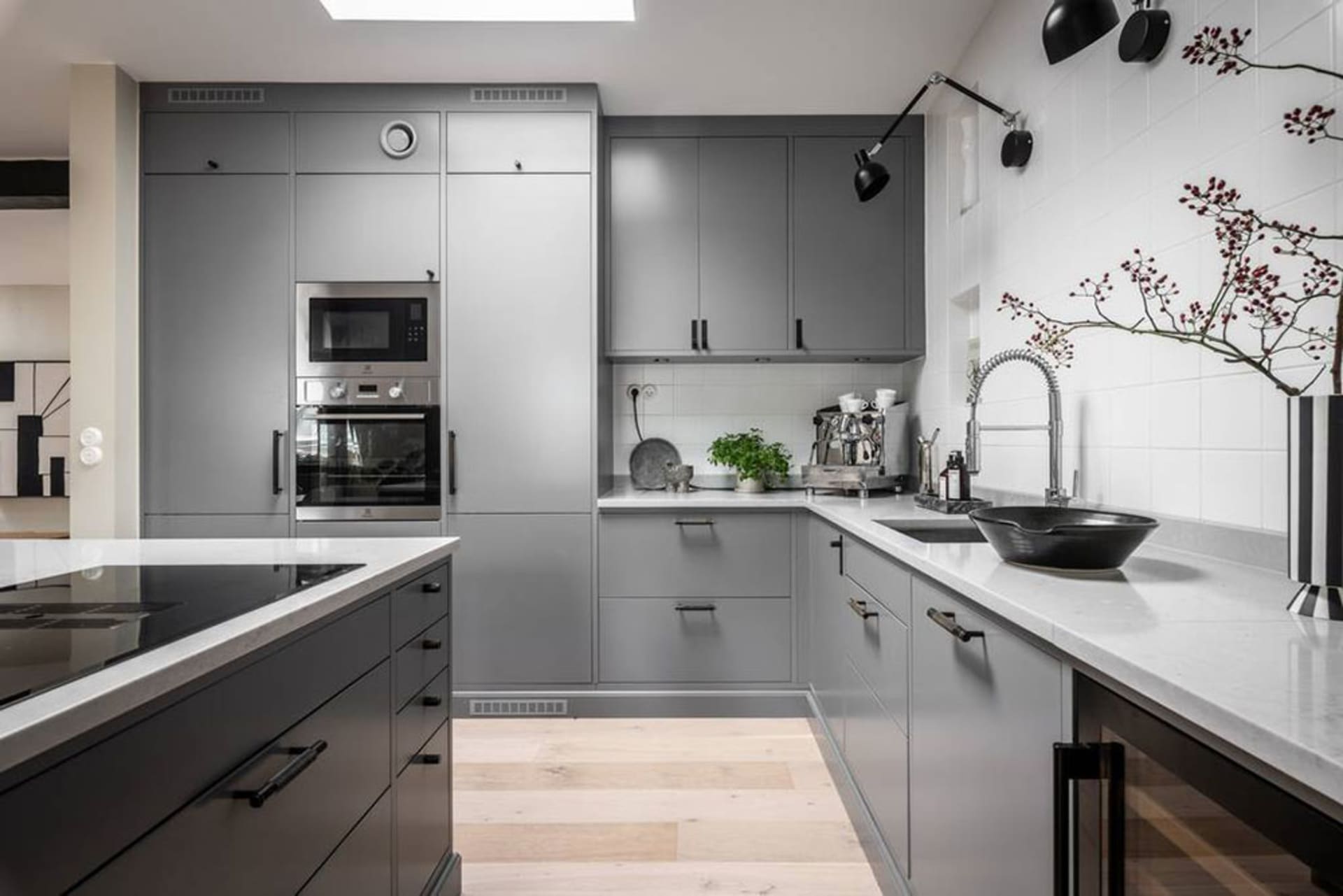 Modern contemporary kitchen featuring gray cabinets and white countertops with a sleek, minimalist design and a touch of indu