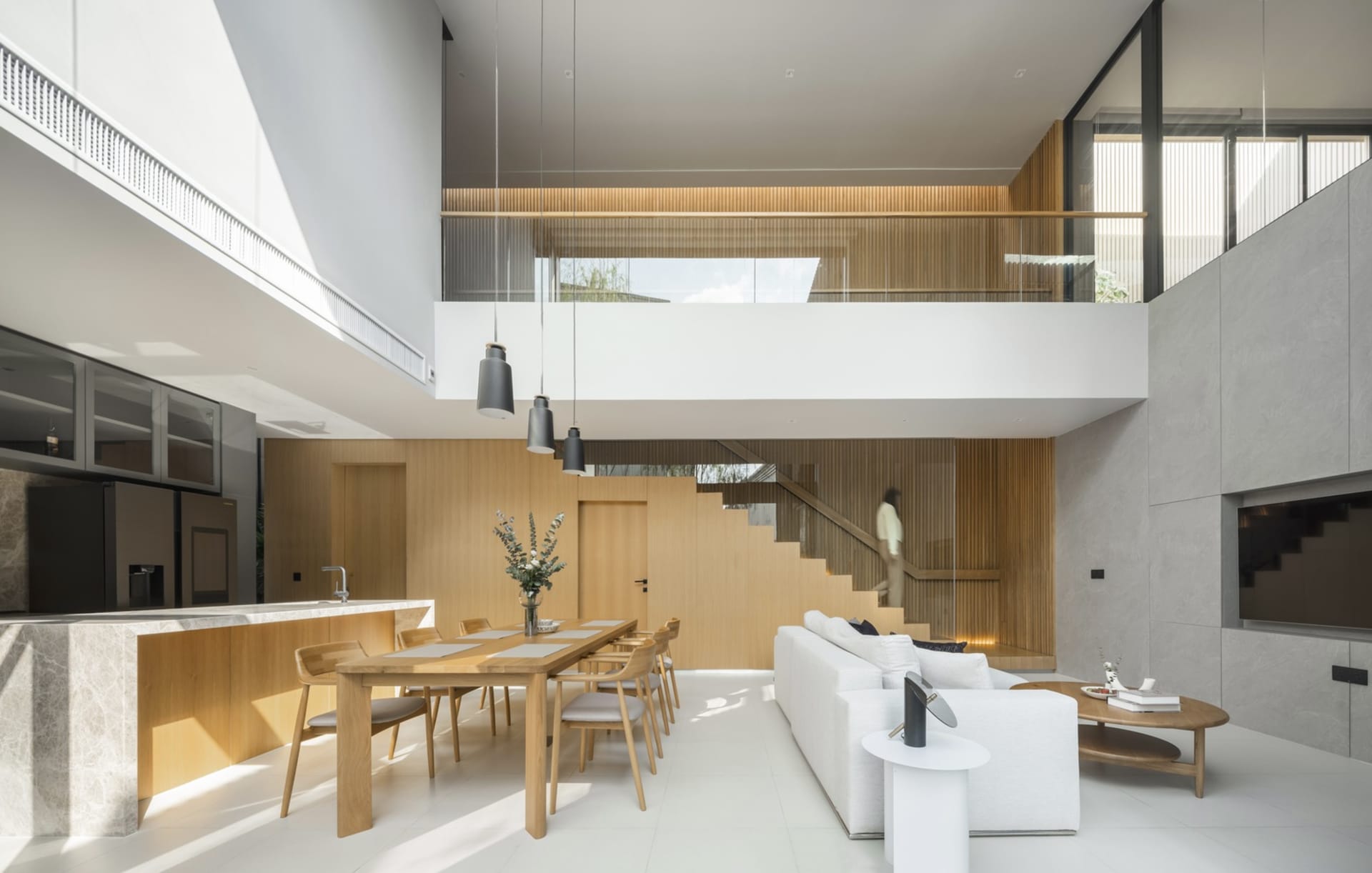A modern residential interior featuring minimalist design and use of wood, marble, and glass materials.