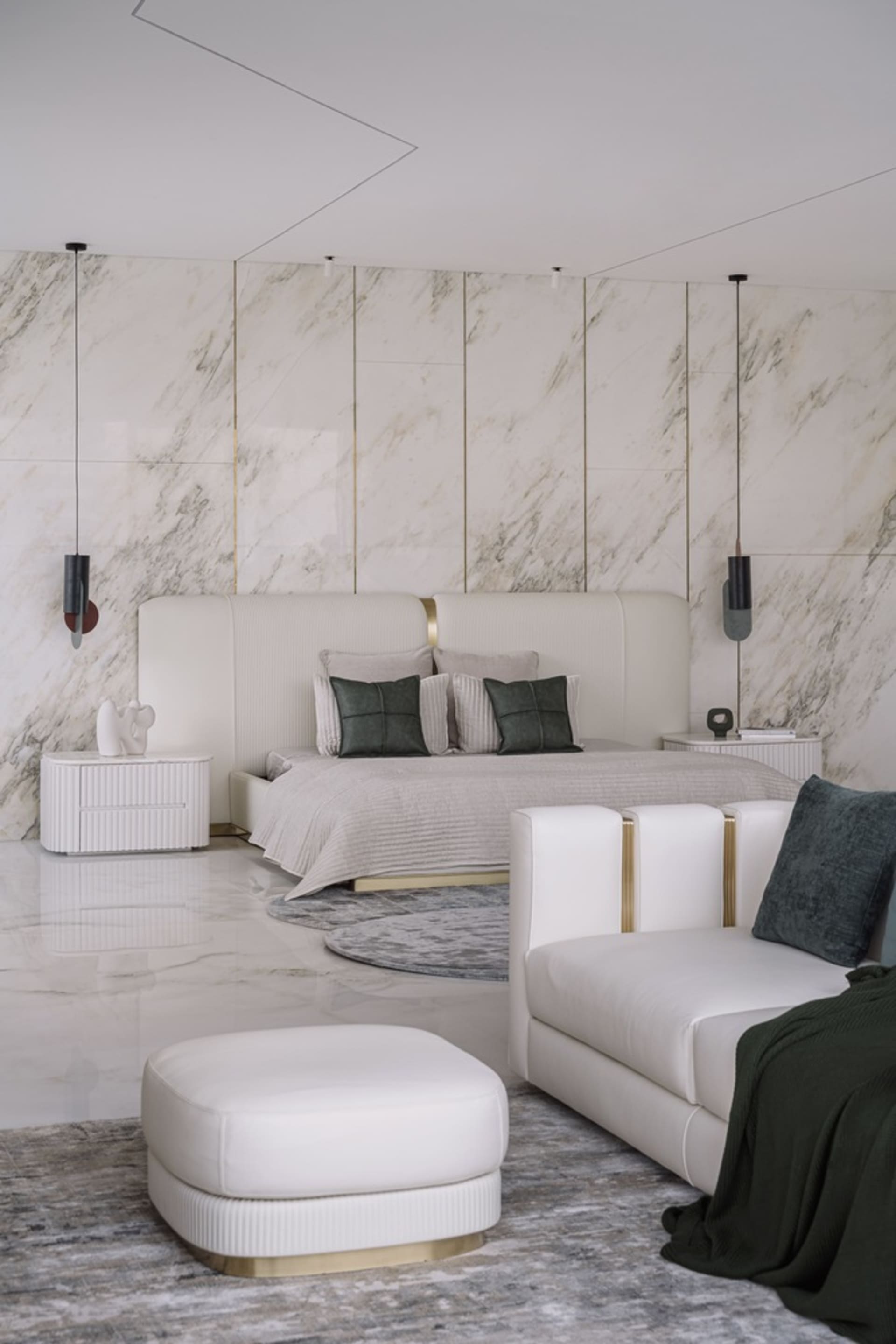 A modern bedroom featuring marble accents, a minimalist design, and a plush seating area.