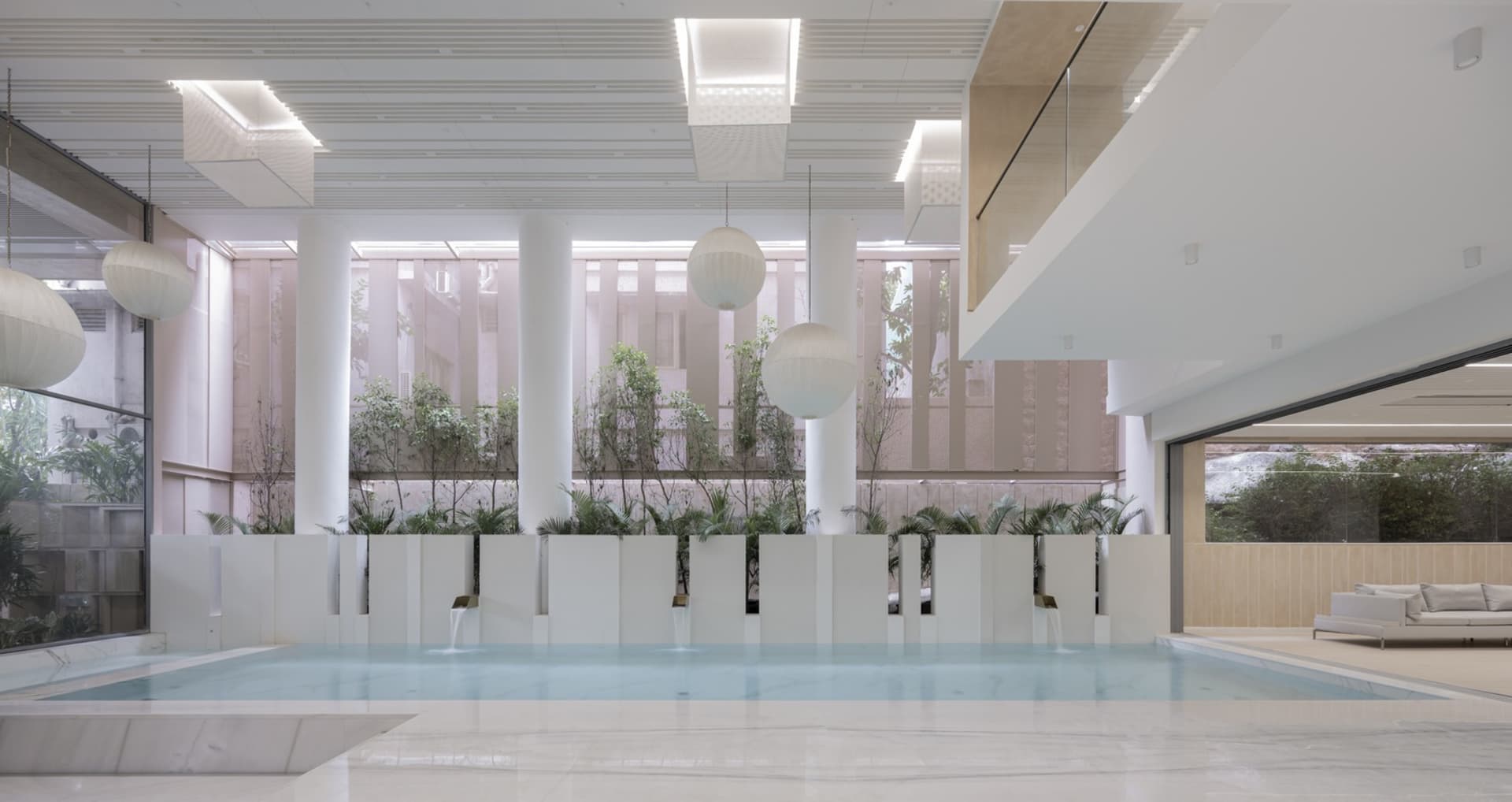 A modern swimming pool with minimalist design and concrete terraces.