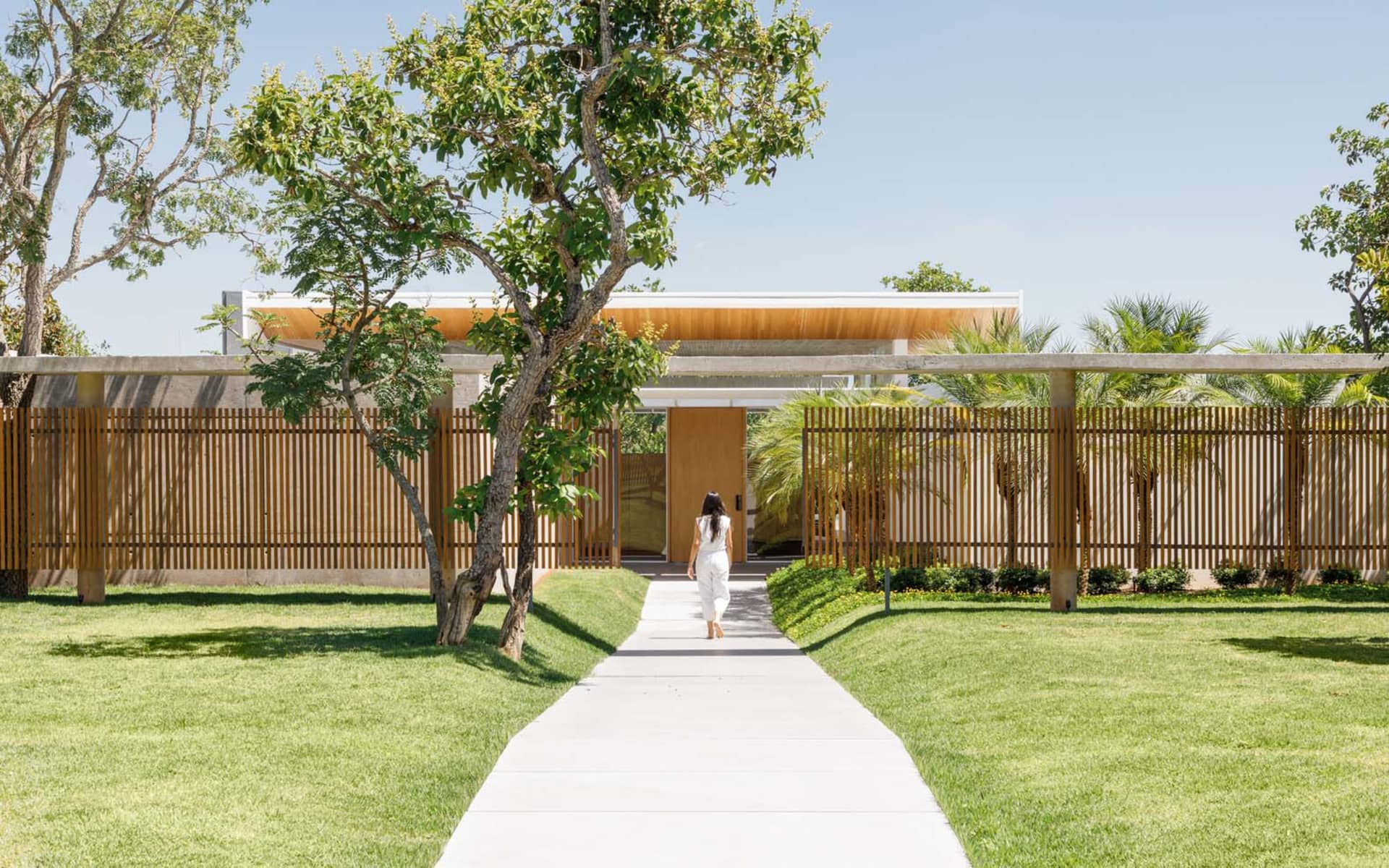 A modern exterior residential home featuring wood and concrete materials.