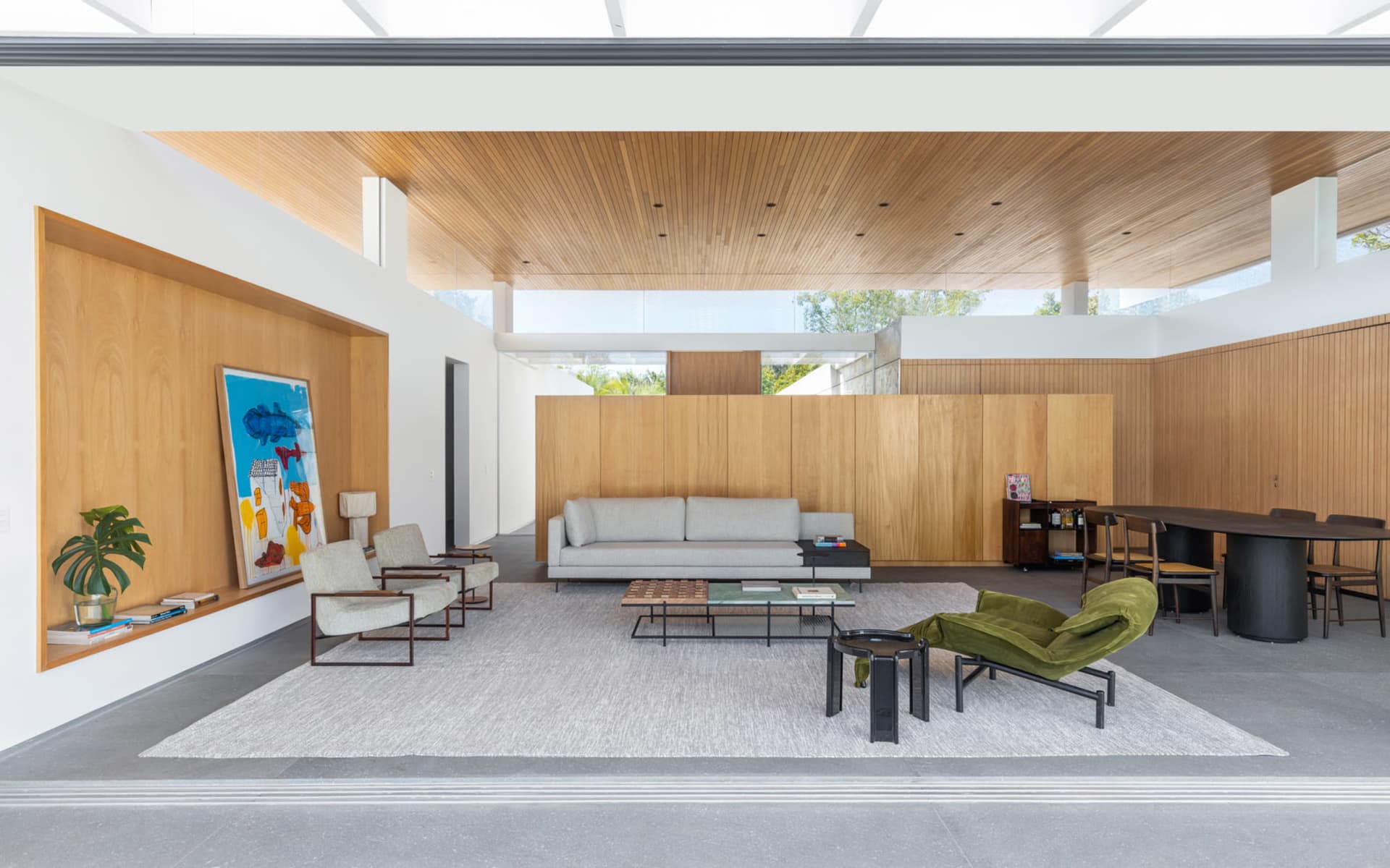 Modern residential interior featuring a contemporary wood design with a white ceiling, gray flooring, and a large window.