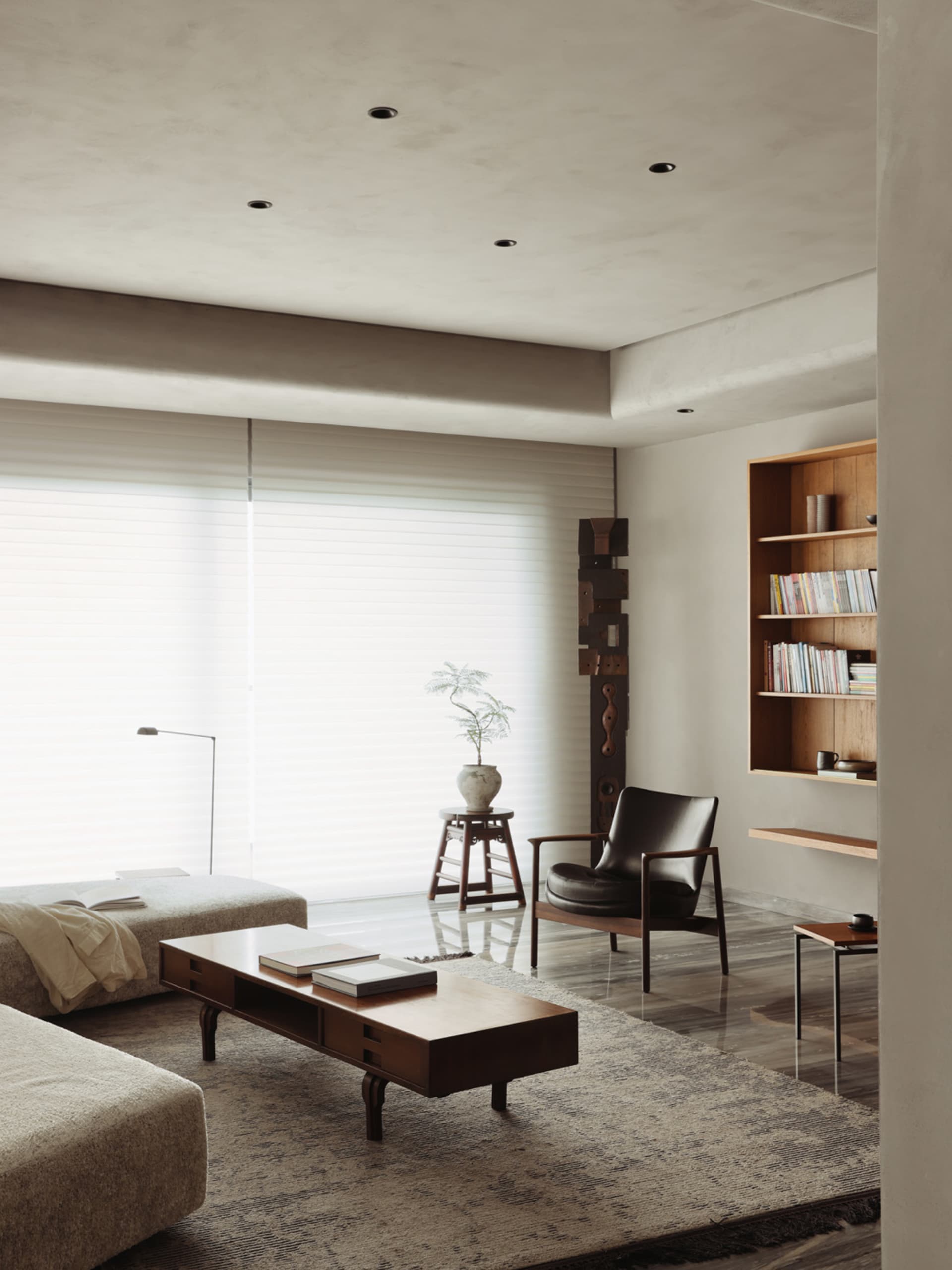 Contemporary living room featuring wooden furniture, leather accents, and a cozy ambiance.