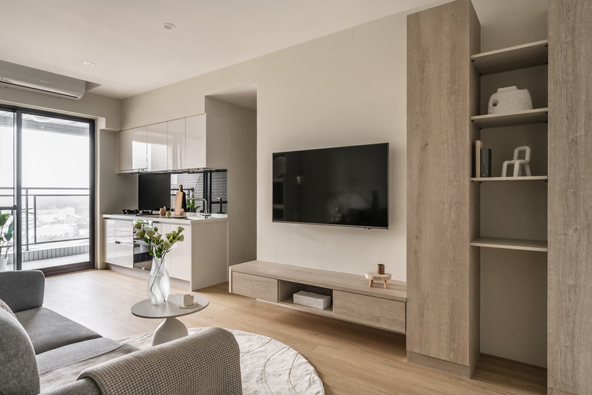 A modern minimalist living room featuring wood, glass, and metal materials.
