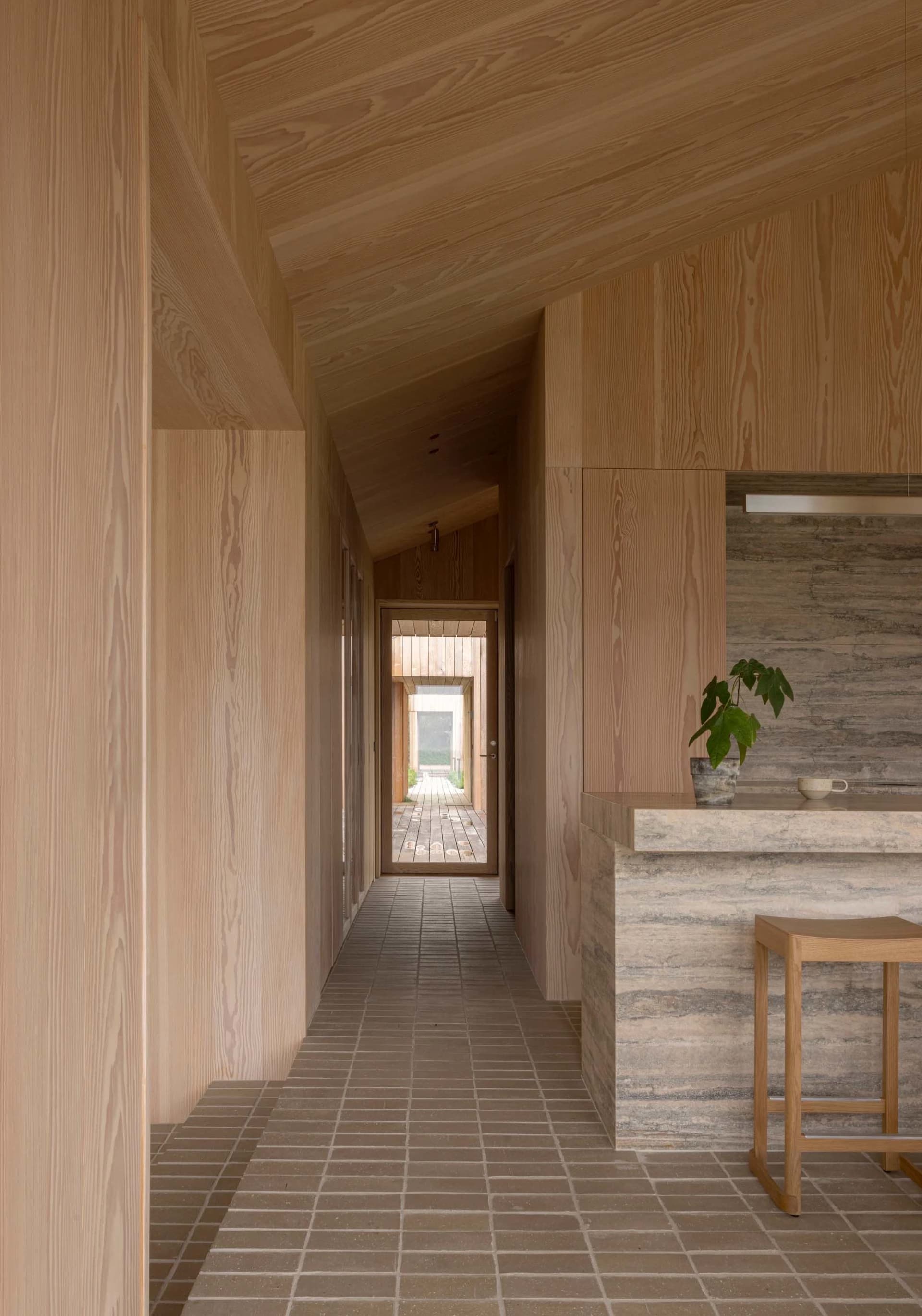 A minimalist residential interior featuring wood and porcelain tile