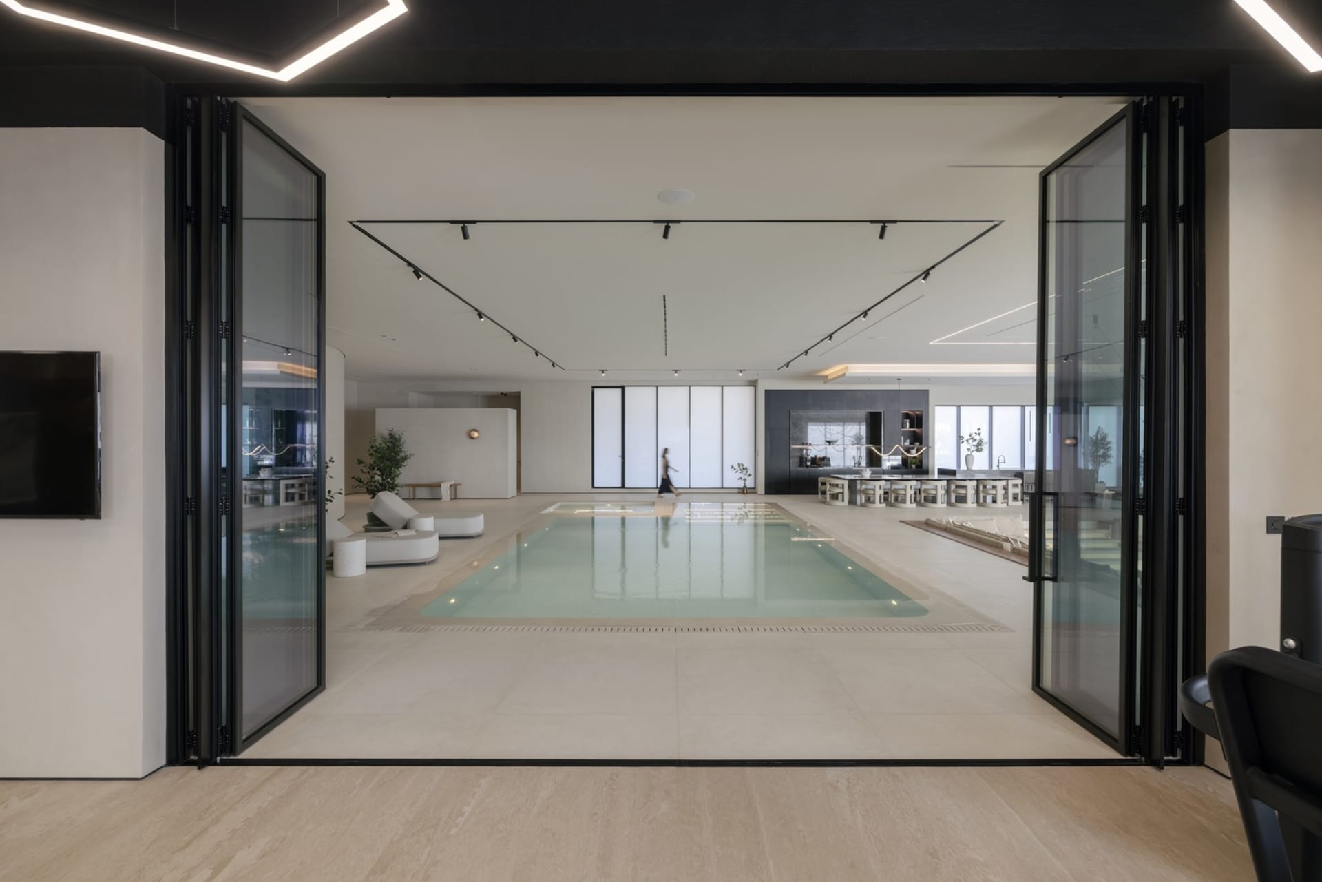 A modern, industrial residential interior with a concrete floor and minimalist design.