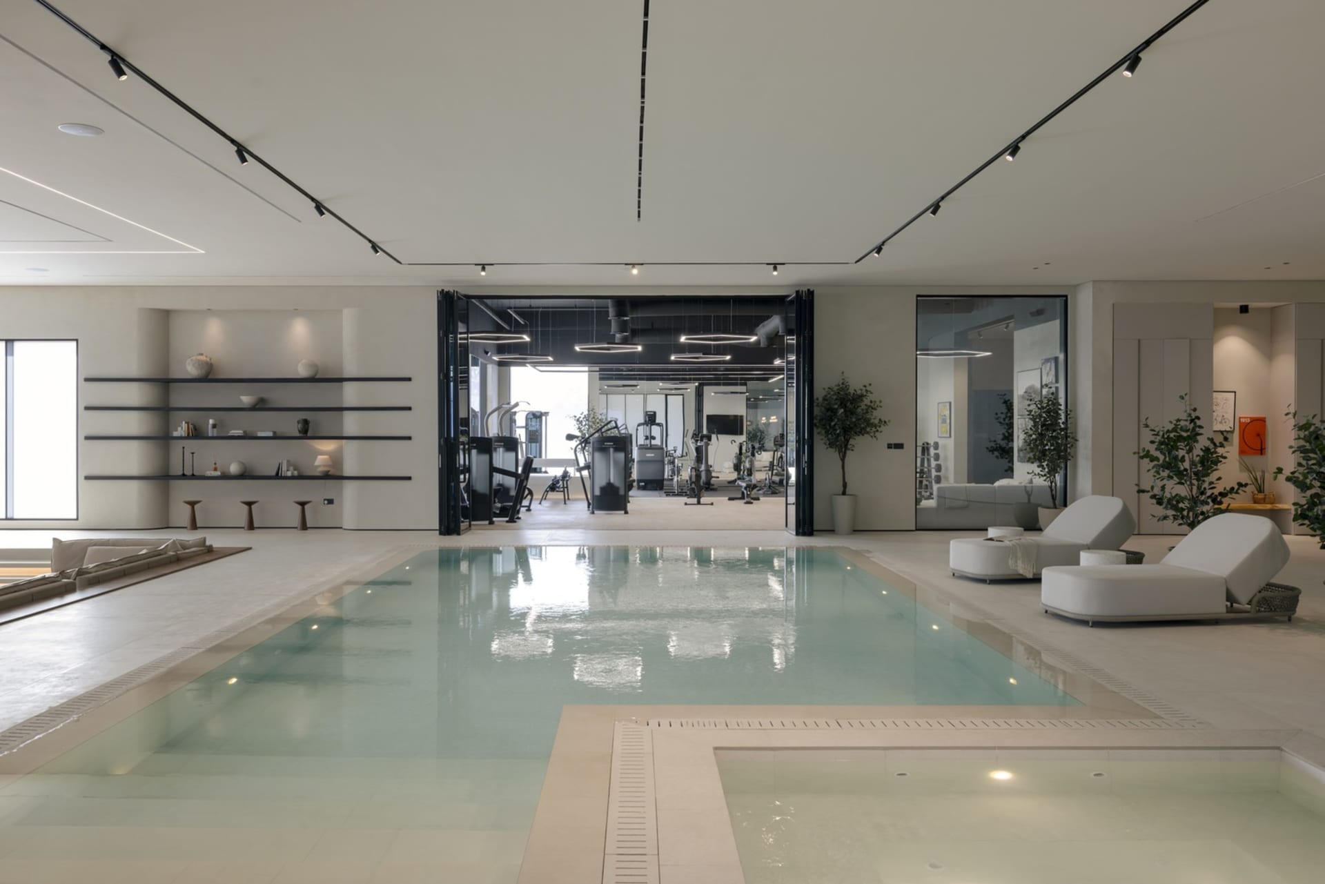 Modern, minimalist gym and swimming pool concept with sleek, clean lines and a neutral color palette.