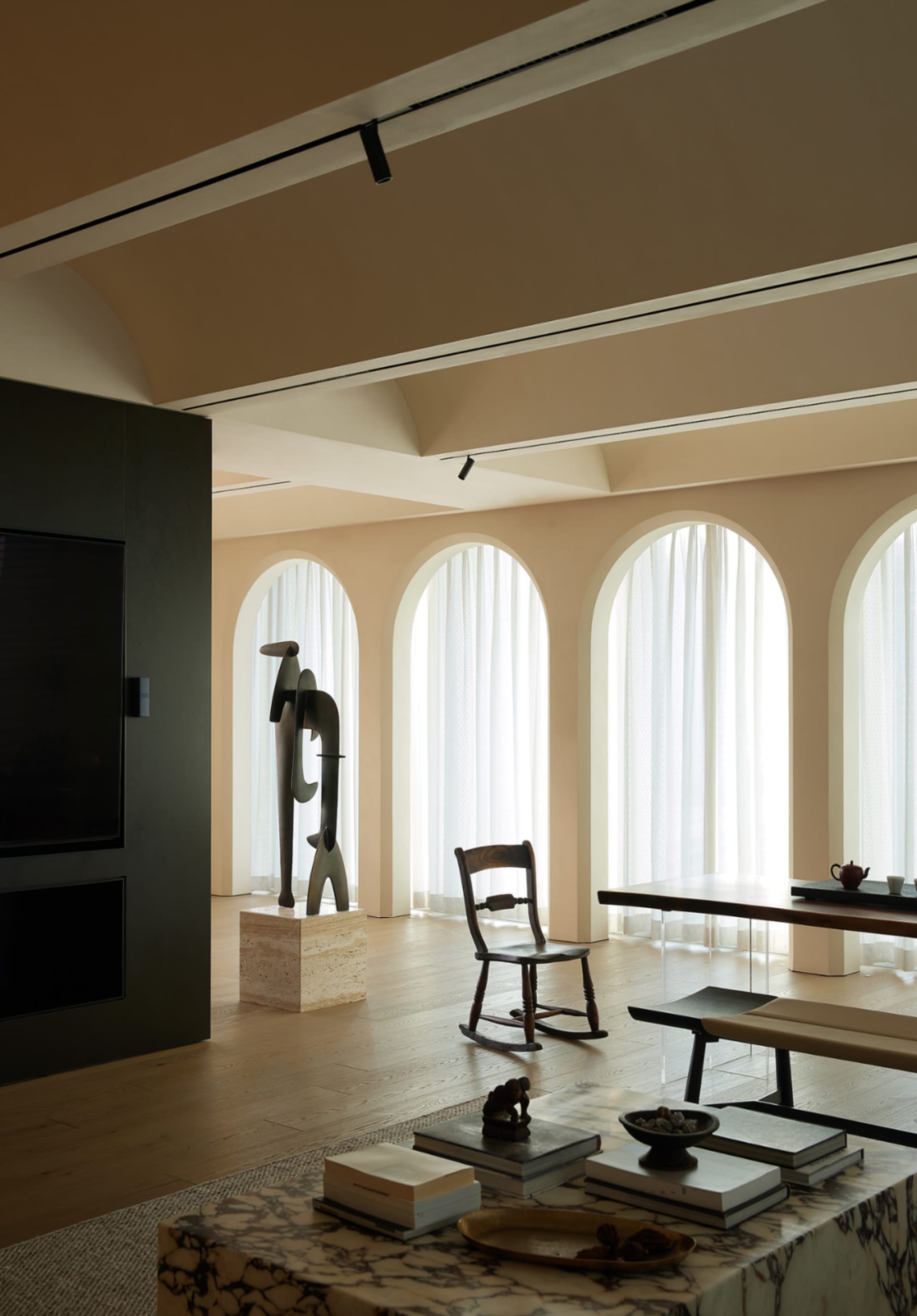 Contemporary living room featuring marble surfaces and wooden elements.