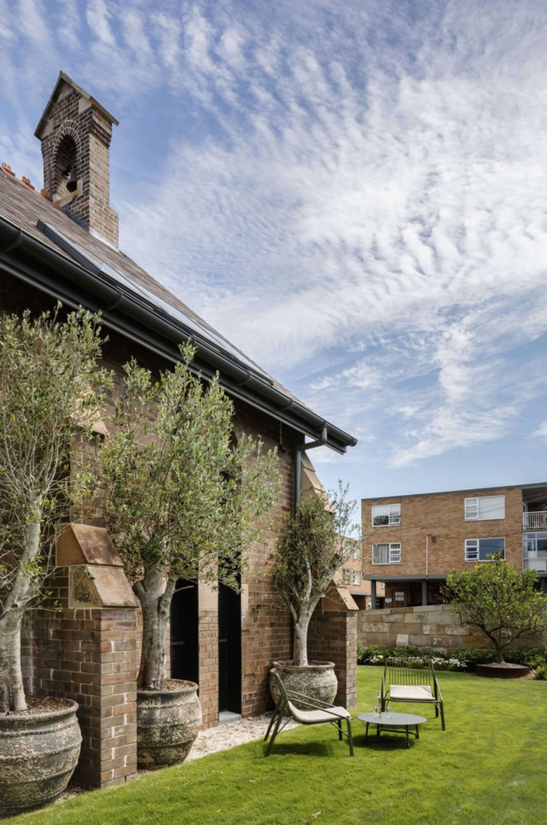 A modern residential exterior with brick, glass, and metal accents.